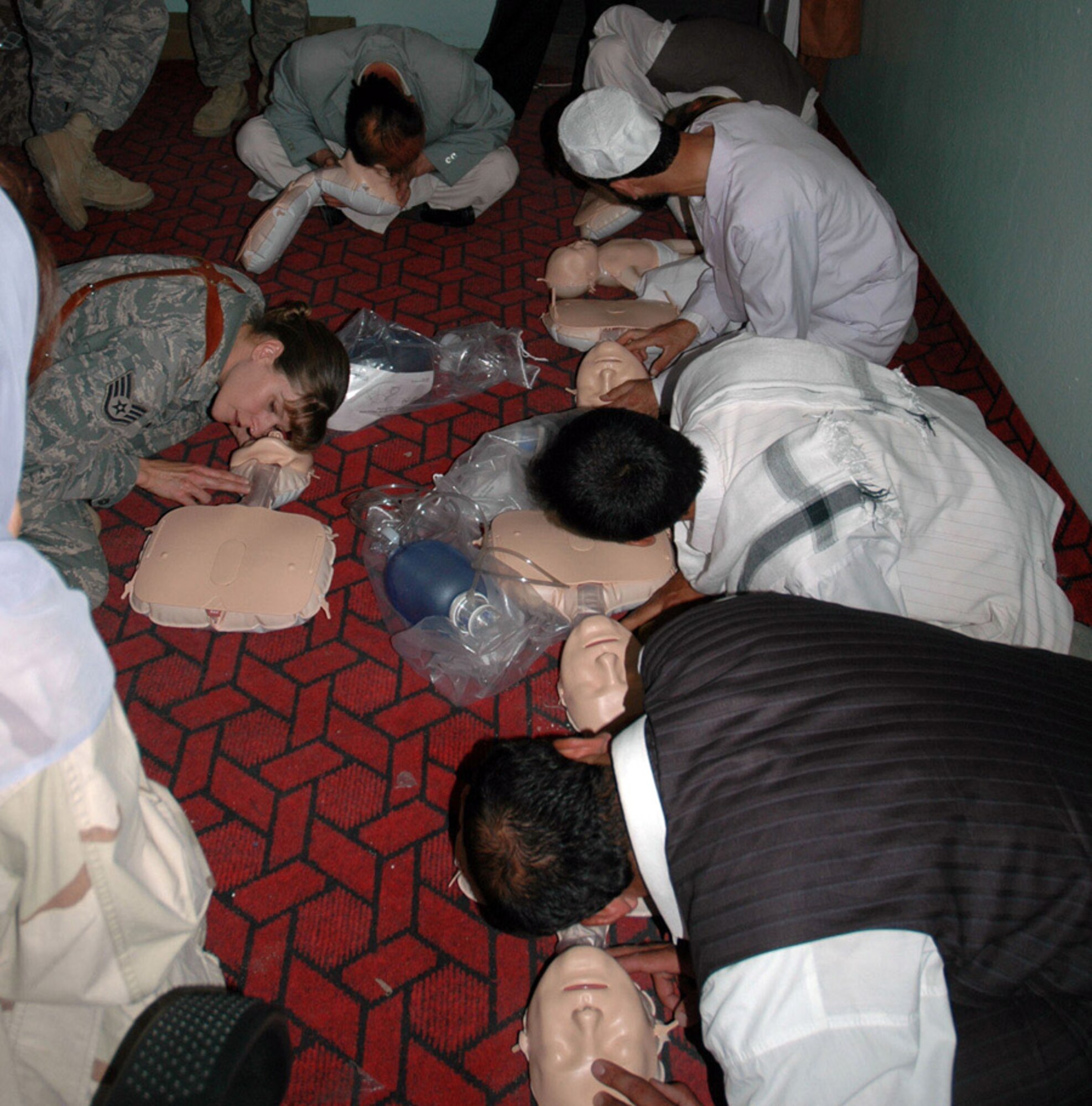 Staff Sgt. Janine Duschka teaches the jaw thrust maneuver to Afghan medical providers during a CPR class June 18 at the Rokha Clinic in the Panjshir Province in Afghanistan. This was the first session of a 15-class CPR program that the Panjshir PRT is providing this year. Sergeant Duschka is a Panjshir Provincial Reconstruction Team medical technician. (U.S. Air Force photo/Capt. Jillian Torango) 
