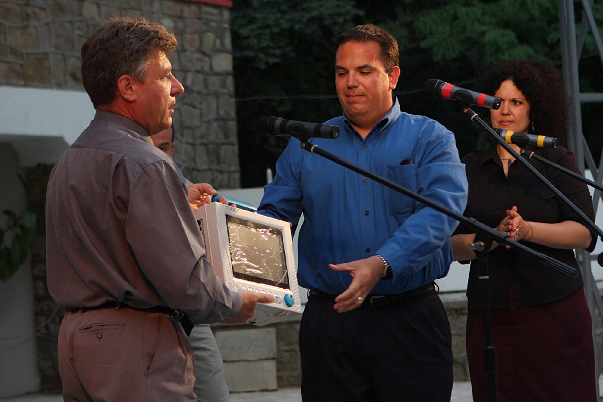GRAF IGNATIEVO AIR BASE, BULGARIA - Chaplain (Maj.) Vincent Cummings, 482nd Fighter Wing chaplain, presents a new cardiac monitor to Dr. Stefan Lazarov from the Medical University in Plovdiv, Bulgaria, at the closing ceremonies of a two-week deployment to Graf-Isnatievo Air Base, Bulgaria. Approximately 200 Airmen and 10 F-16s from Homestead Air Reserve Base deployed to train with the Bulgarian Air Force MiG 21 and 29 fighter jets. While deployed, the Airmen raised $2,800 to purchase the medical device for the children’s ward at the hospital in the nearby City of Plovdiv. (U.S. Air Force photo by Tech. Sgt. Bucky Parrish)