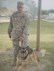 6/3/2008 -- Army Spc. Nicholas Rempp restrains military working dog Roy during the Military Working Dog Handlers Course at Lackland Air Force Base, Texas, on June 3, 2007. Specialist Rempp lost his right leg in Iraq when an improvised explosive device detonated. (USAF photo by Meredith Canales)