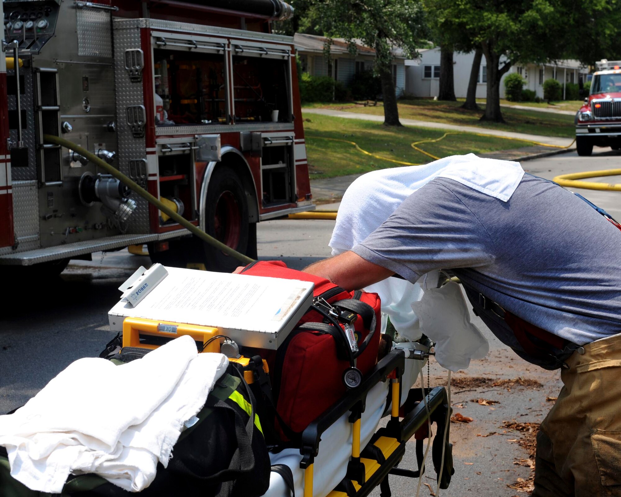 SHAW AIR FORCE BASE, S.C.-- A Shaw firefighter rests and breaths some oxygen after exiting a house fire June 20. The house is in an area marked for demolition and was not occupied. (U.S. Air Force Photo/Staff Sgt. Henry Hoegen)
