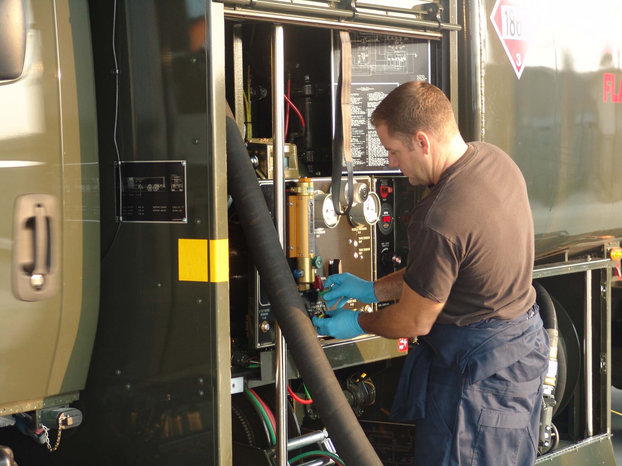 Tech Sgt. Brent Rouse, 96th Fuels Flight preventative maintenance supervisor, checks the gauges on a refueler.  A cold check of each refueler conserves fuel, an AFSO 21 initiative. (USAF photo by Lois Walsh)
