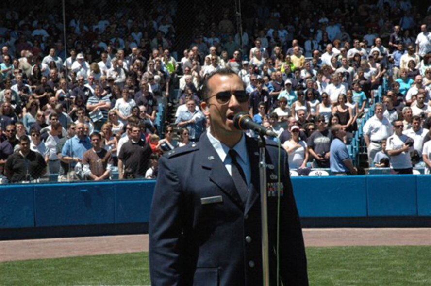 Capt. Edward Torres, 919th Logistics Readiness Squadron officer, sings the National Anthem before a special New York Yankees versus Seattle Mariners game that recognized the heritage of the Tuskegee Airmen May 25 at the Yankee Stadium in New York. (Courtesy Photo)
