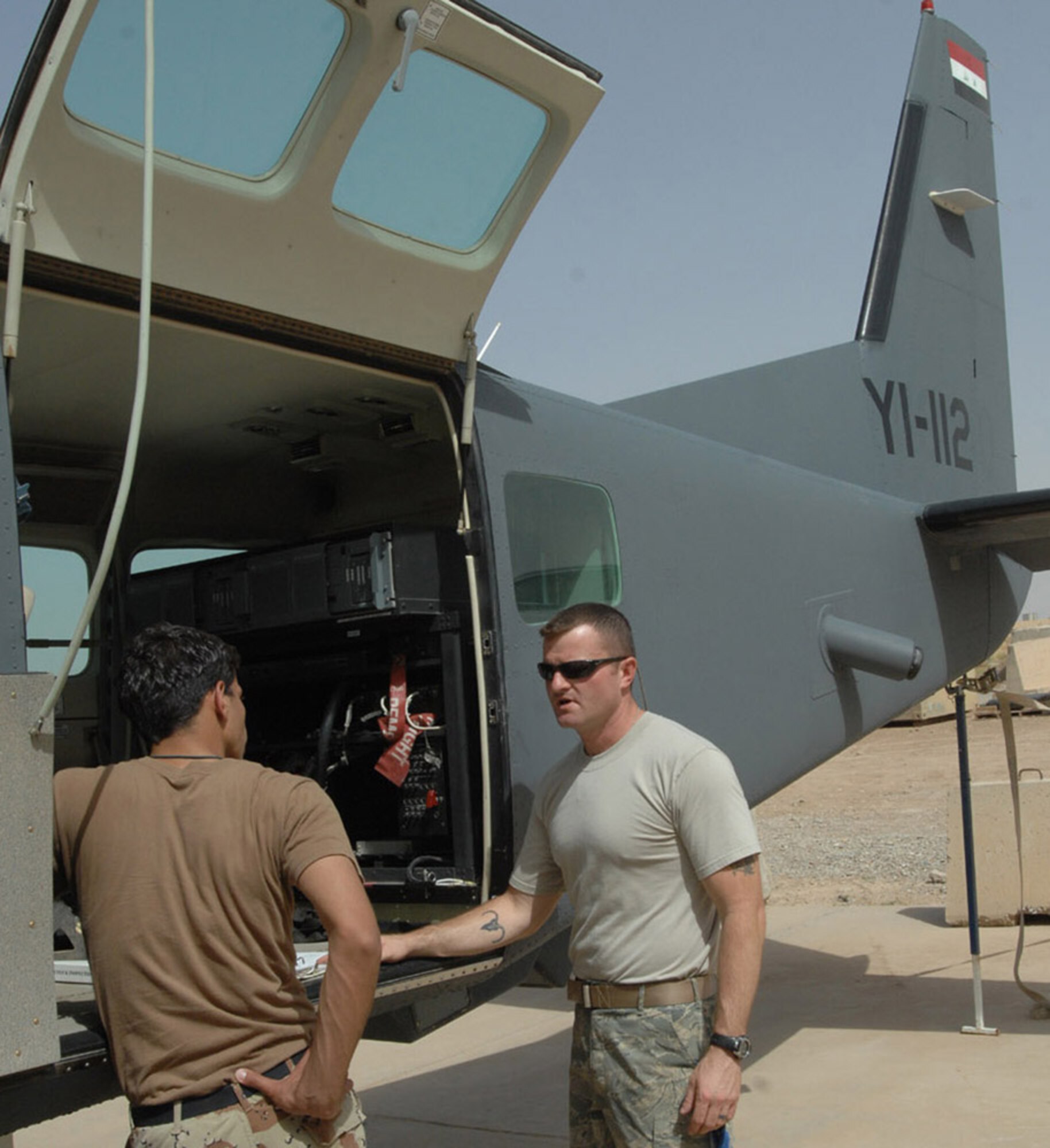 KIRKUK REGIONAL AIR BASE, Iraq - An Iraqi maintainer from the 3rd Squadron reviews technical orders with the help of Tech Sgt. Robbie Leist, 870th Expeditionary Air Advisory Squadron. While Iraqi Air Force pilots continue flying sorties to aid stability in their nation, Iraqi maintainers on the ground here have recently achieved important benchmarks to keep their fleet in the air. Airmen with the Iraqi Air Forces’ 3rd Squadron here took over a wide variety of maintenance duties on the unit’s Cessna 208 Caravan Intelligence, Surveillance and Reconnaissance fleet – a task formerly performed by U.S. contractors. (U.S. Air Force photo by Senior Airman Eric Schloeffel)