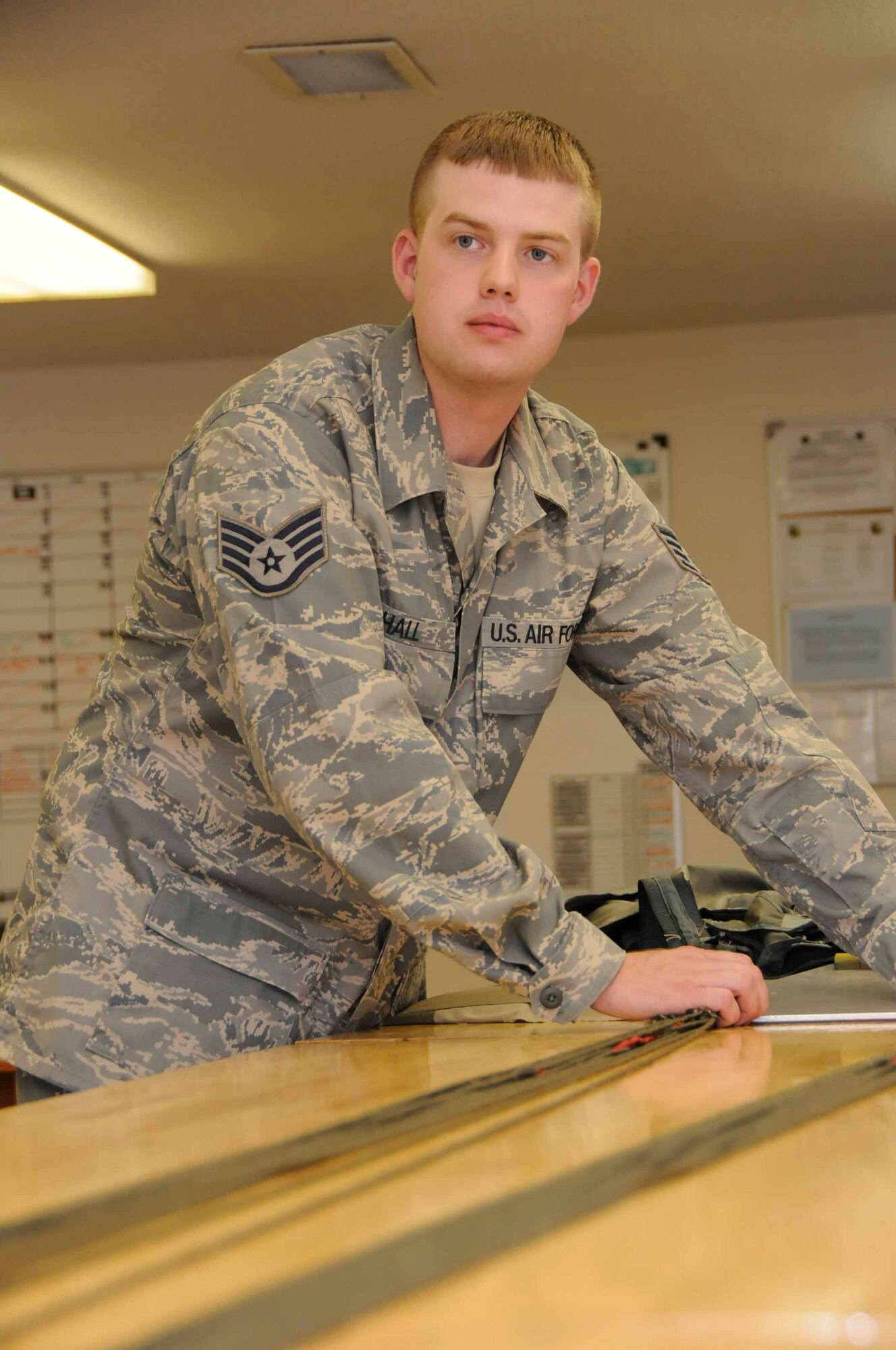 SOUTHWEST ASIA—Staff Sgt. Craig Hall, 379th Expeditionary Operations Squadron Aircrew Flight Equipment Technician assists with a line continuity check June 14. Line continuity and airing the canopy are two details that go hand in hand in making sure that lines aren’t twisted. (U.S. Air Force photo/ Senior Airman Domonique Simmons)