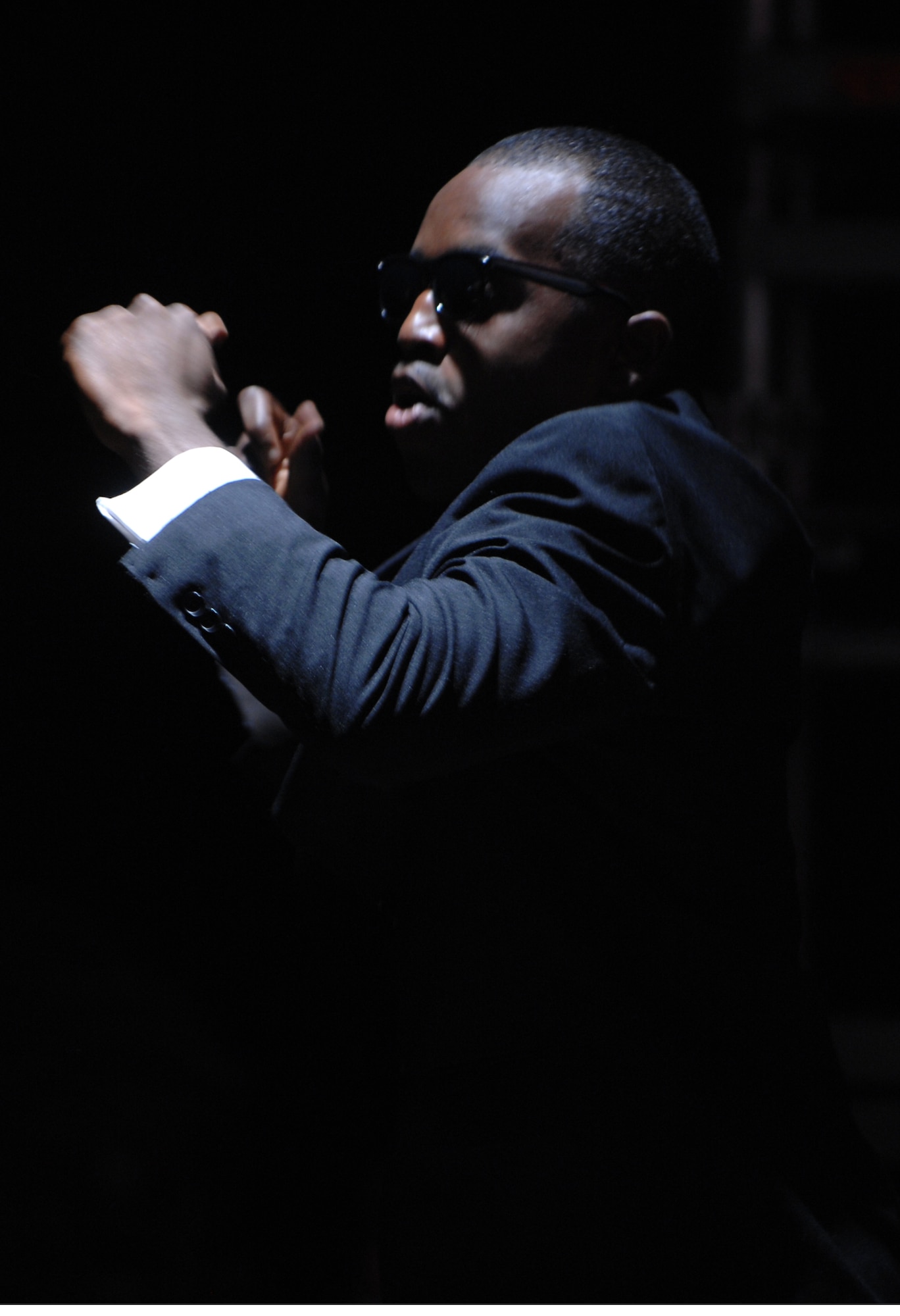 Tops in Blue dancer Staff Sgt. Corey Sims performs a hip-hop number to the "Men in Black" theme song during this year's Tops in Blue concert held at the Rushmore Plaza Civic Center in Rapid City, S.D., June 19. Tops In Blue is the Air Force's premier entertainment showcase which brings together the best in music, dance and comedy. (U.S. Air Force photo/Airman Corey Hook)(Released) 


