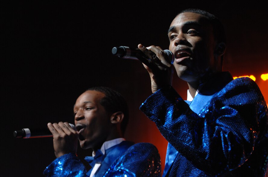 (From Right to Left) Tops in Blue Vocalists Airmen 1st Class Barry Smith and Quentin Thomas sing during this year's Tops in Blue concert held at the Rushmore Plaza Civic Center in Rapid City, S.D., June 19. Tops In Blue Airmen perform an average of 120 performances at 100 locations worldwide each year. (U.S. Air Force photo/Airman Corey Hook)(Released) 


