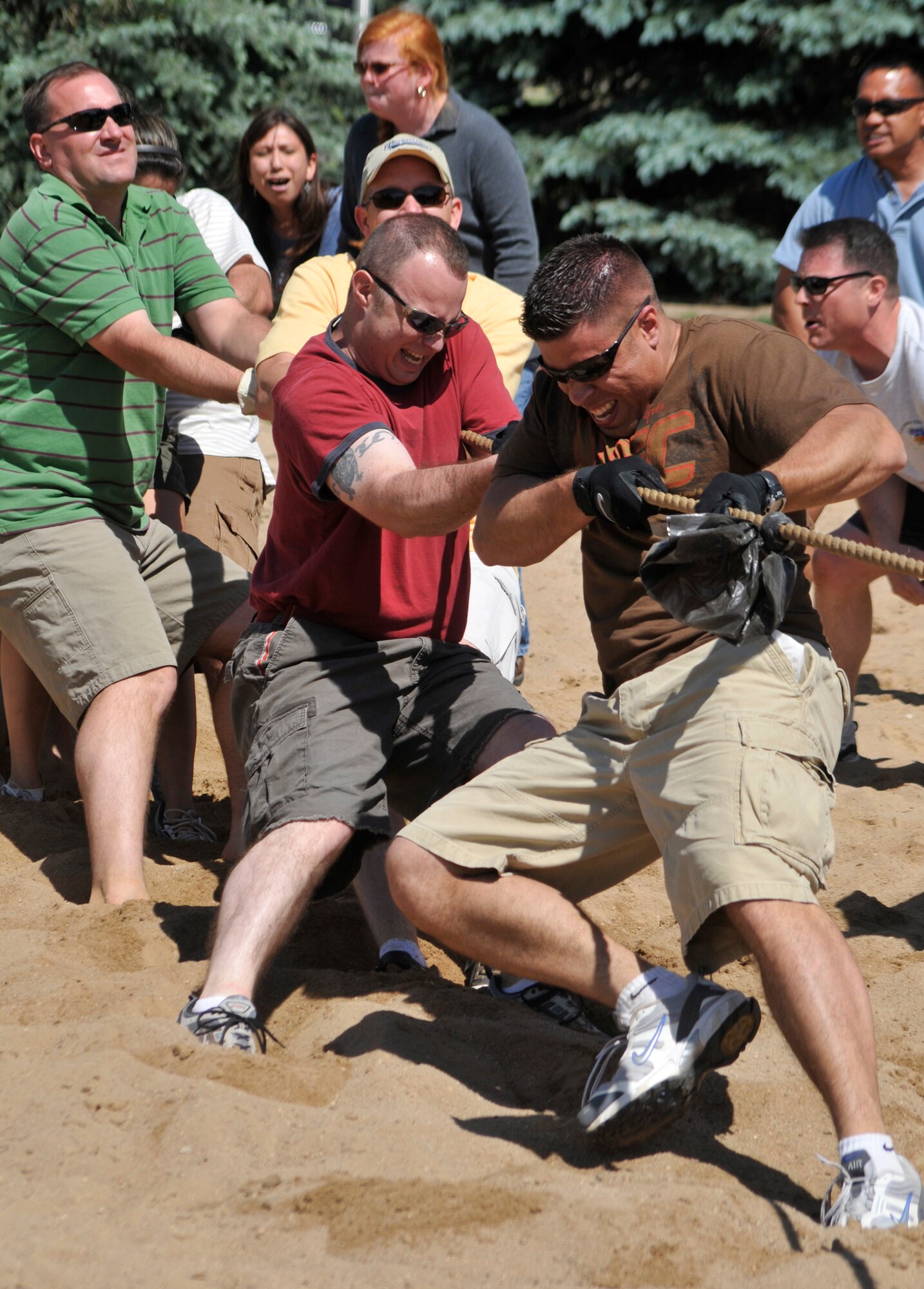 A 21st Space Wing tug-of-war team struggles to stay in the competition during Sports Day activities June 19 at Peterson Air Force Base, Colo. Sports Day is an annual event that gives members of the wing time to build teamwork skills and boost morale. The event also offers the wing a chance to flex its “Fit to Fight” muscles. (U.S. Air Force photo/Larry Hulst) 