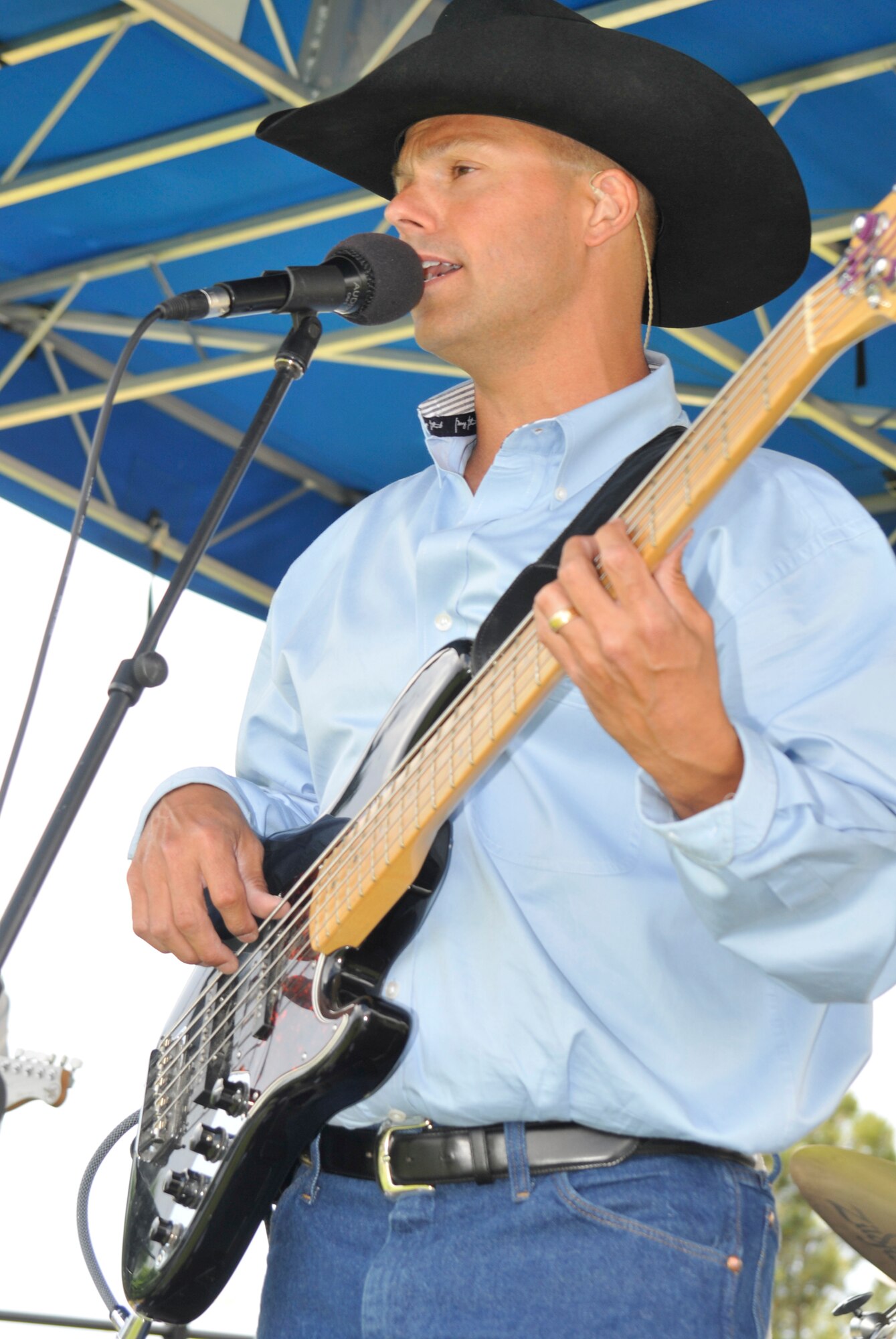 A member of the U.S. Air Force Academy band “Wild Blue Country” sings his heart out during Sports Day activities June 19 at Peterson Air Force Base, Colo. Sports Day is an annual event that gives members of the wing time to build teamwork skills and boost morale. The event also offers the wing a chance to flex its “Fit to Fight” muscles. (U.S. Air Force photo/Larry Hulst)