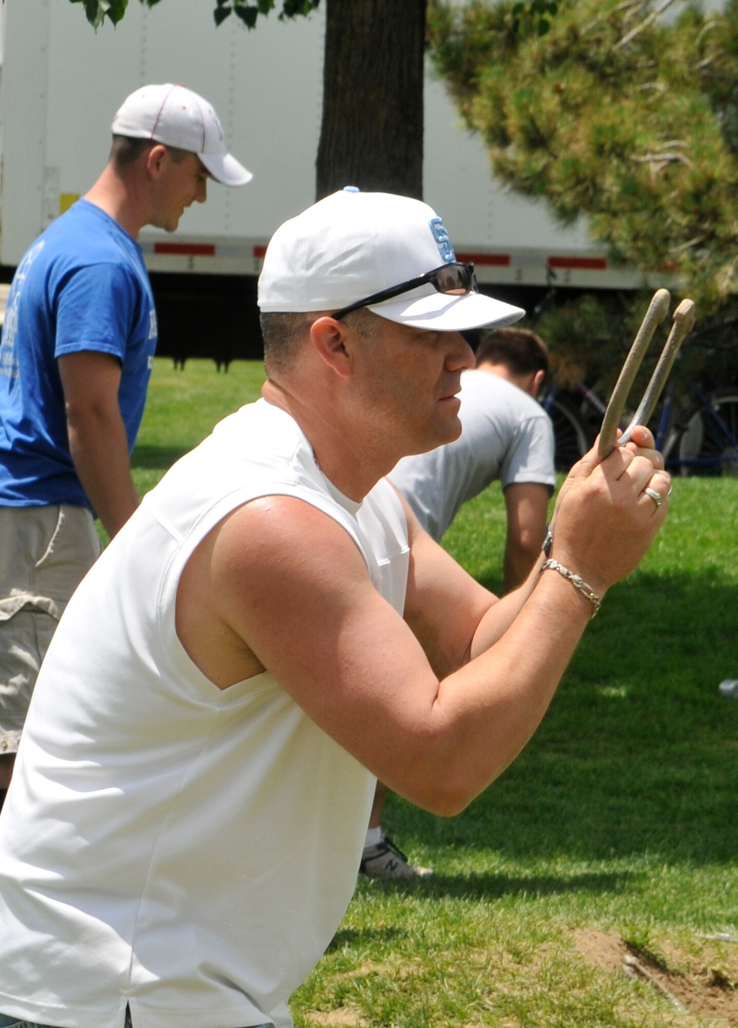 A 21st Space Wing member prepares to toss his horseshoe during Sports Day activities June 19 at Peterson Air Force Base, Colo. Sports Day is an annual event that gives members of the wing time to build teamwork skills and boost morale. The event also offers the wing a chance to flex its “Fit to Fight” muscles. (U.S. Air Force photo/Larry Hulst)