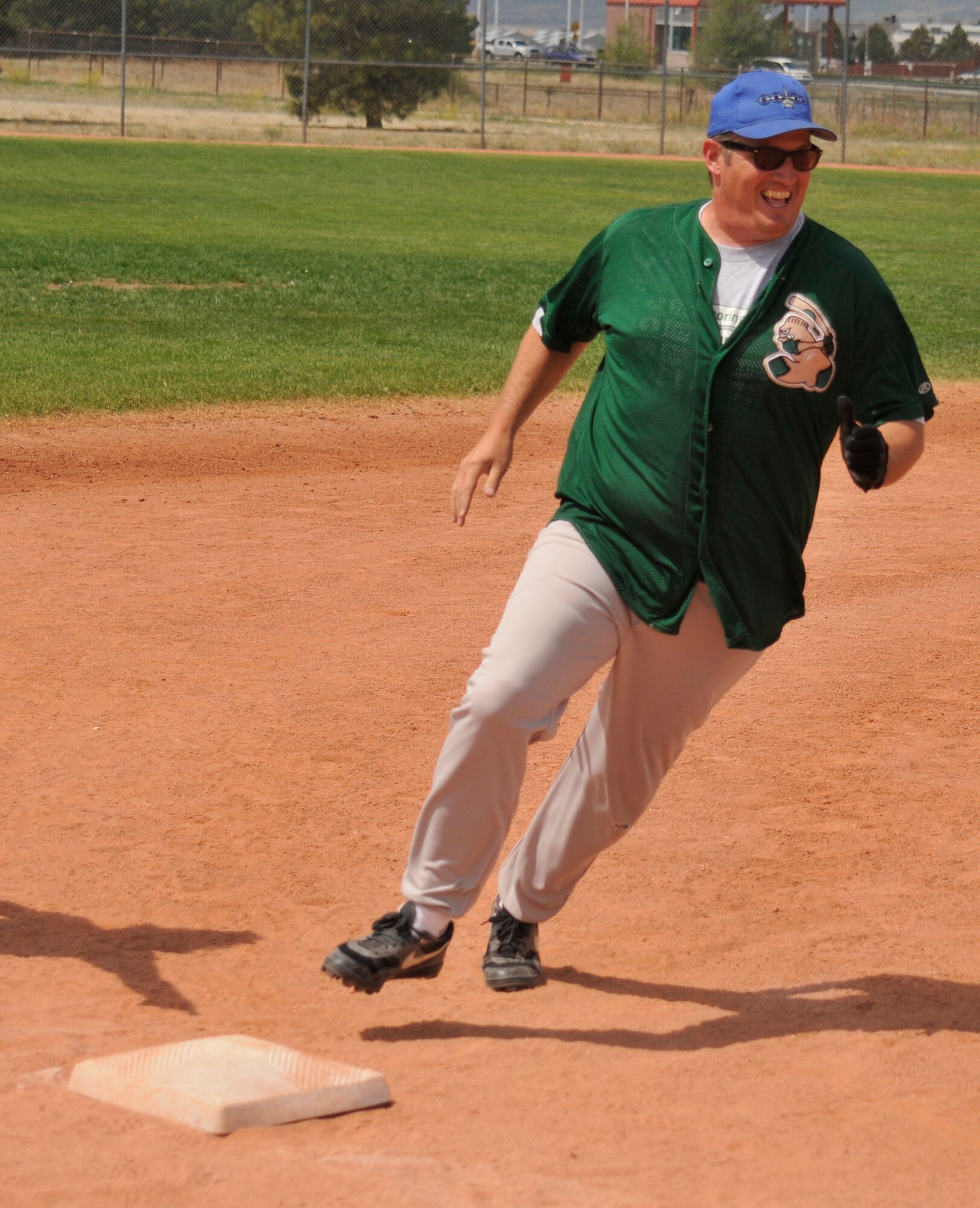 A 21st Space Wing member rounds third base while playing softball during Sports Day activities June 19 at Peterson Air Force Base, Colo. Sports Day is an annual event that gives members of the wing time to build teamwork skills and boost morale. The event also offers the wing a chance to flex its “Fit to Fight” muscles. (U.S. Air Force photo/Larry Hulst)