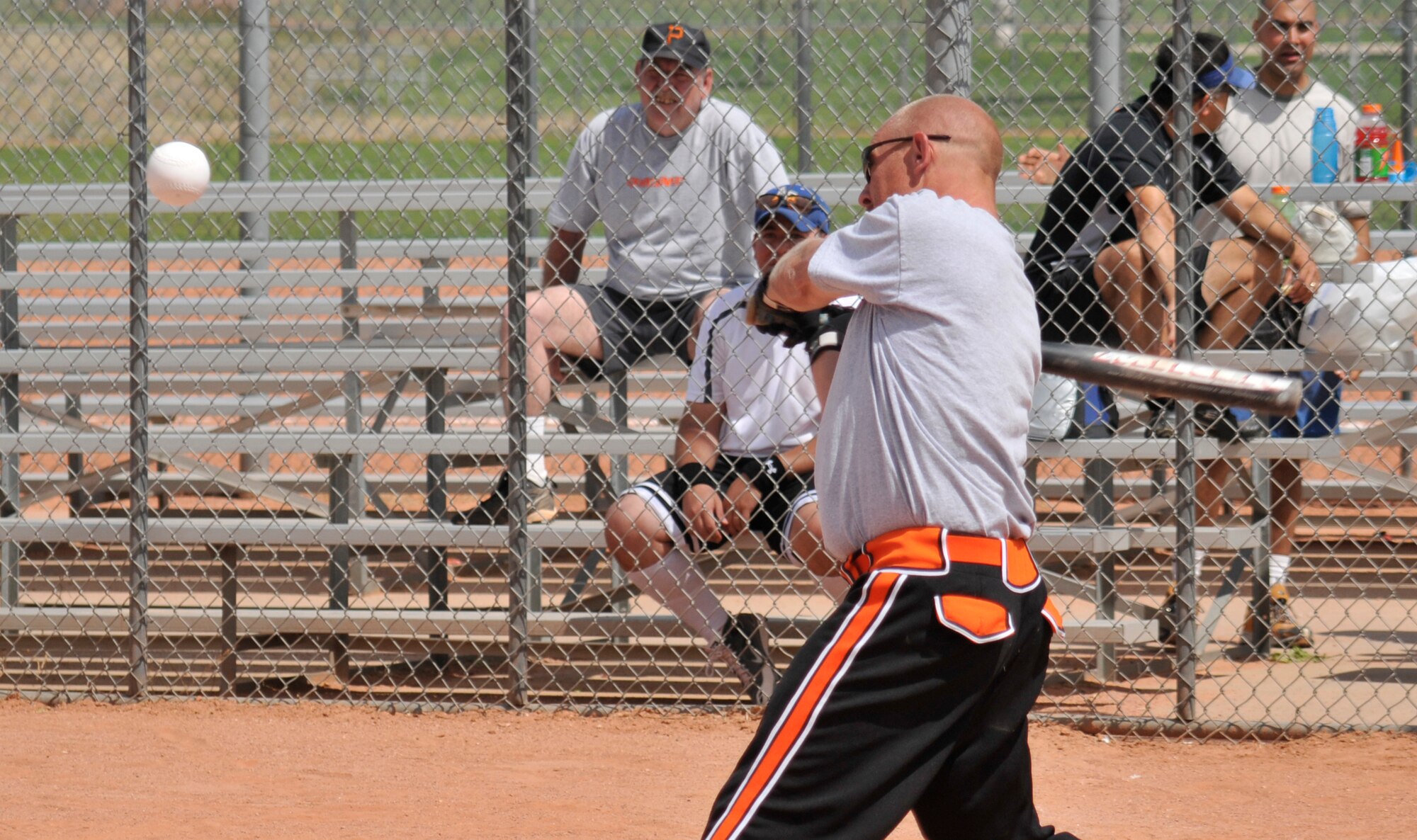 A 21st Space Wing member swings for a right fielder while playing softball during Sports Day activities June 19 at Peterson Air Force Base, Colo. Sports Day is an annual event that gives members of the wing time to build teamwork skills and boost morale. The event also offers the wing a chance to flex its “Fit to Fight” muscles. (U.S. Air Force photo/Larry Hulst)