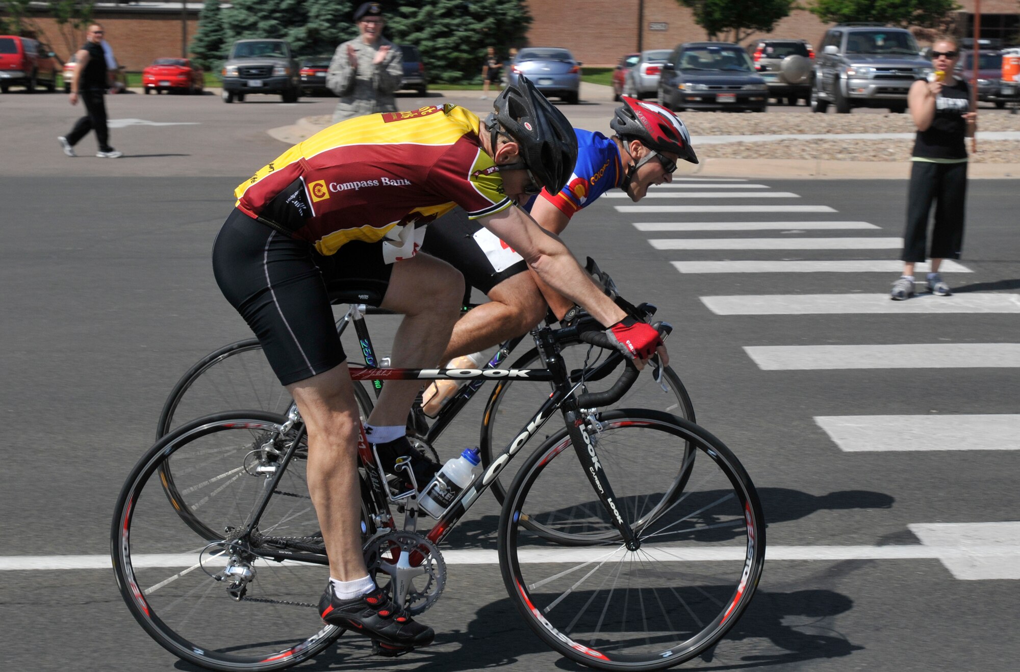Bicyclists from the 21st Space Wing ride their way to the finish line during Sports Day activities June 19 at Peterson Air Force Base, Colo. Sports Day is an annual event that gives members of the wing time to build teamwork skills and boost morale. The event also offers the wing a chance to flex its “Fit to Fight” muscles. (U.S. Air Force photo/Larry Hulst)