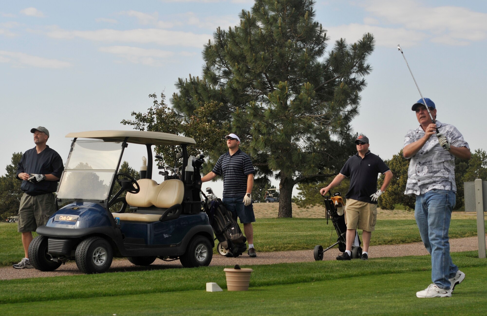 Members of the 21st Space Wing watch as a long drive falls from the summer sky during Sports Day activities June 19 at Peterson Air Force Base, Colo. Sports Day is an annual event that gives members of the wing time to build teamwork skills and boost morale. The event also offers the wing a chance to flex its “Fit to Fight” muscles. (U.S. Air Force photo/Larry Hulst)