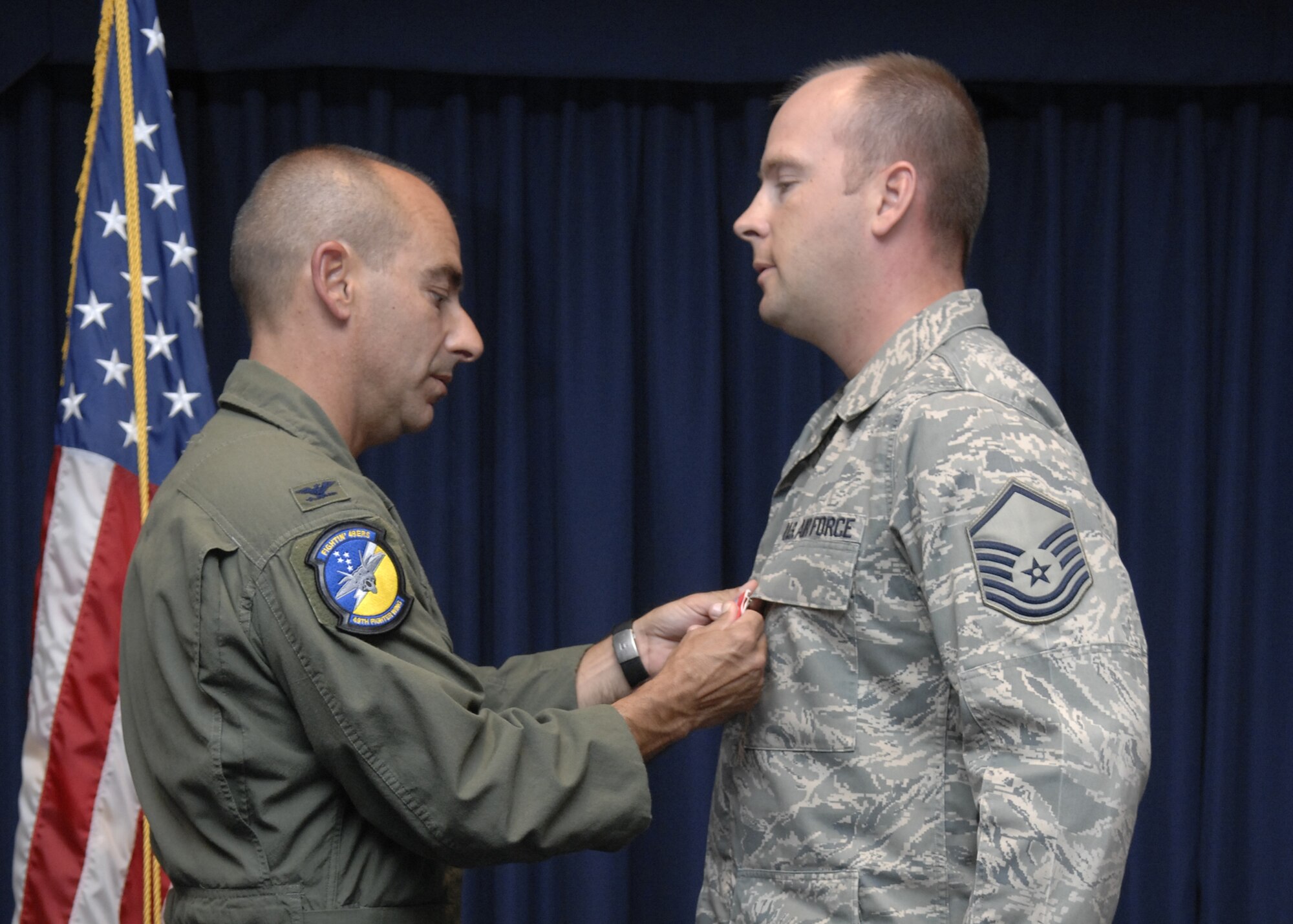 Master Sgt. Jeffrey Brzezinski, 49th Logistics Readiness Squadron, receives a Bronze Star Medal from Col. Jeff Harrigian, 49th Fighter Wing commander during Warrior Call, June 20 at the Desert Sands Enlisted Club at Holloman Air Force Base, N.M. The Bronze Star is an individual military decoration which may be awarded for bravery, acts of merit or meritorious service. (U.S. Air Force photo/Airman 1st Class Rachel A. Kocin)