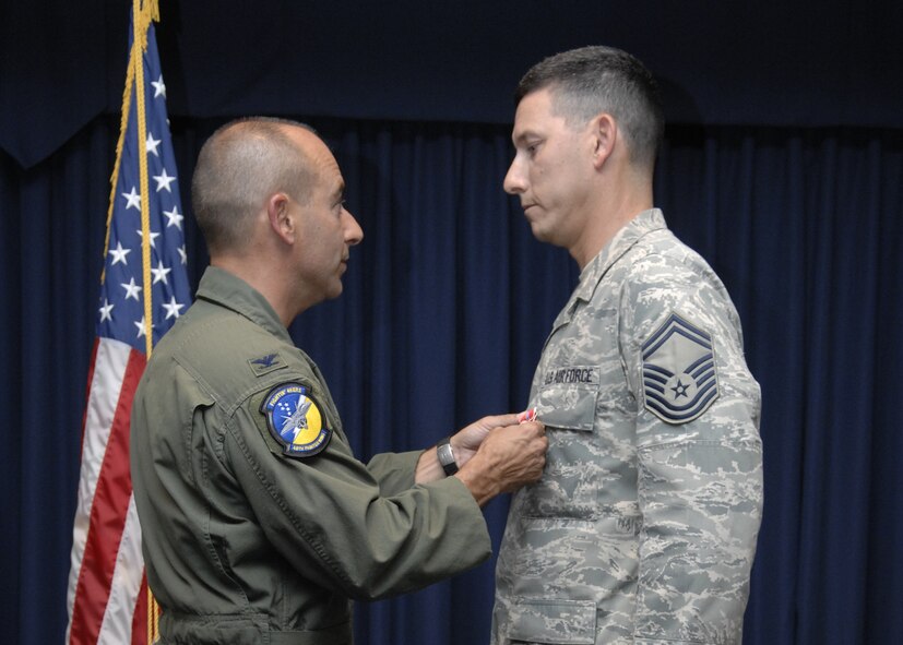 Senior Master Sgt. Billy Davis, 49th Logistics Readiness Squadron, receives his second Bronze Star Medal from Col. Jeff Harrigian, 49th Fighter Wing commander during Warrior Call, June 20 at the Desert Sands Enlisted Club at Holloman Air Force Base, N.M. When a Bronze Star Award is awarded for bravery, it is the fourth-highest award in the U.S. Armed Forces. (U.S. Air Force photo/Airman 1st Class Rachel A. Kocin)