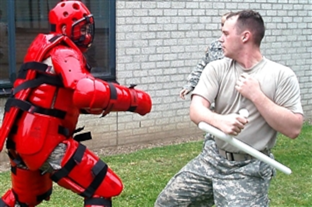 U.S. Army Sgt. Gerold Westley, right, takes a swing at Army Sgt. Sean Kolar, who is wearing a Redman suit during training exercises at U.S. Army Garrison Schinnen, Netherlands, June 23, 2008. Made of thick foam, the suit allows the wearer to withstand blunt force without harm. 