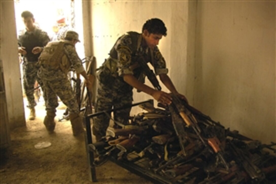 Iraqi soldiers store more than 150 confiscated weapons near Sadr City, Baghdad, June 18, 2008. The weapons were found during several cordon and search missions. 