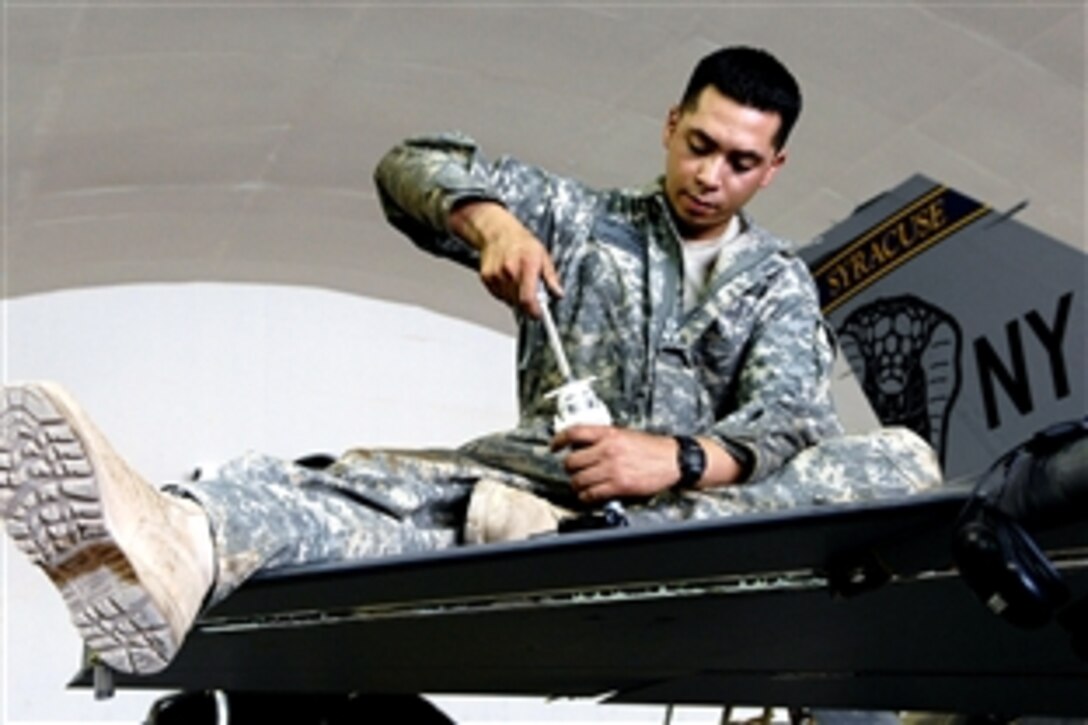 U.S. Air Force Staff Sgt. Caesar Rivera rotates an actuator for the leading edge flap test of an F-16 Fighting Falcon during an inspection on Joint Base Balad, Iraq, June 18, 2008. Rivera is assigned to the 332nd Expeditionary Aircraft Maintenance Squadron deployed from Nellis Air Force Base, Nev. 
