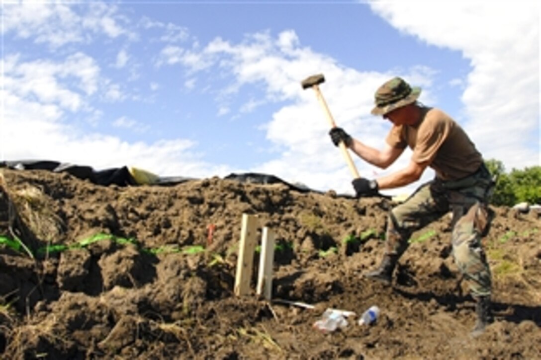 U.S. Air Force Tech. Sgt. Don Reay hammers a stake into the ground to reinforce the Indian Grave Levee in Quincy, Ill., June 22, 2008. Reay is a member of the Illinois Air National Guard, which is working with the Illinois Army Guard to provide security and help recover areas damaged by widespread flooding. 