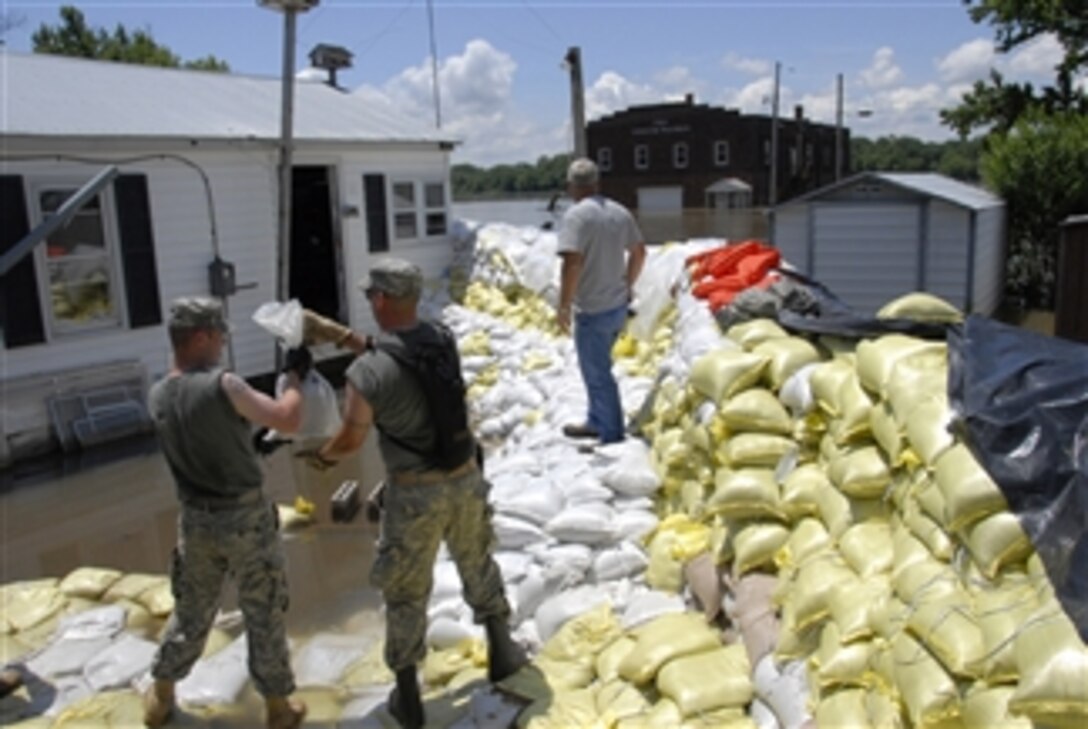 Illinois Army National Guard soldiers reinforce a sandbag wall protecting homes of residents of Hamburg, Ill., on June 20, 2008.  The troops are deployed to support flood relief efforts along the Mississippi River.  