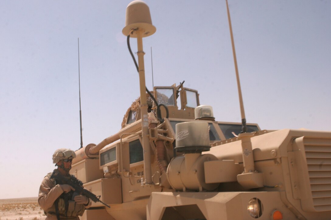 ? A Marine with Team Black Rhino, an Incident Response Team with Marine Wing Support Squadron 374, Marine Wing Support Group 37, 3rd Marine Aircraft Wing (Forward) waits for the Marines in his search team to return to their vehicles during a recent patrol in the Jazirah Desert. While patrolling their area of responsibility, the Marines speak with local Iraqis to gather information.