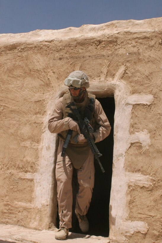 A Marine with Team Black Rhino, an Incident Response Team with Marine Wing Support Squadron 374, Marine Wing Support Group 37, 3rd Marine Aircraft Wing (Forward), exits a room after searching through an abandoned Iraqi compound in the Jazirah Desert. Most of the team members are military police officers, while the rest are comprised of Marines from a variety of military occupational specialties.