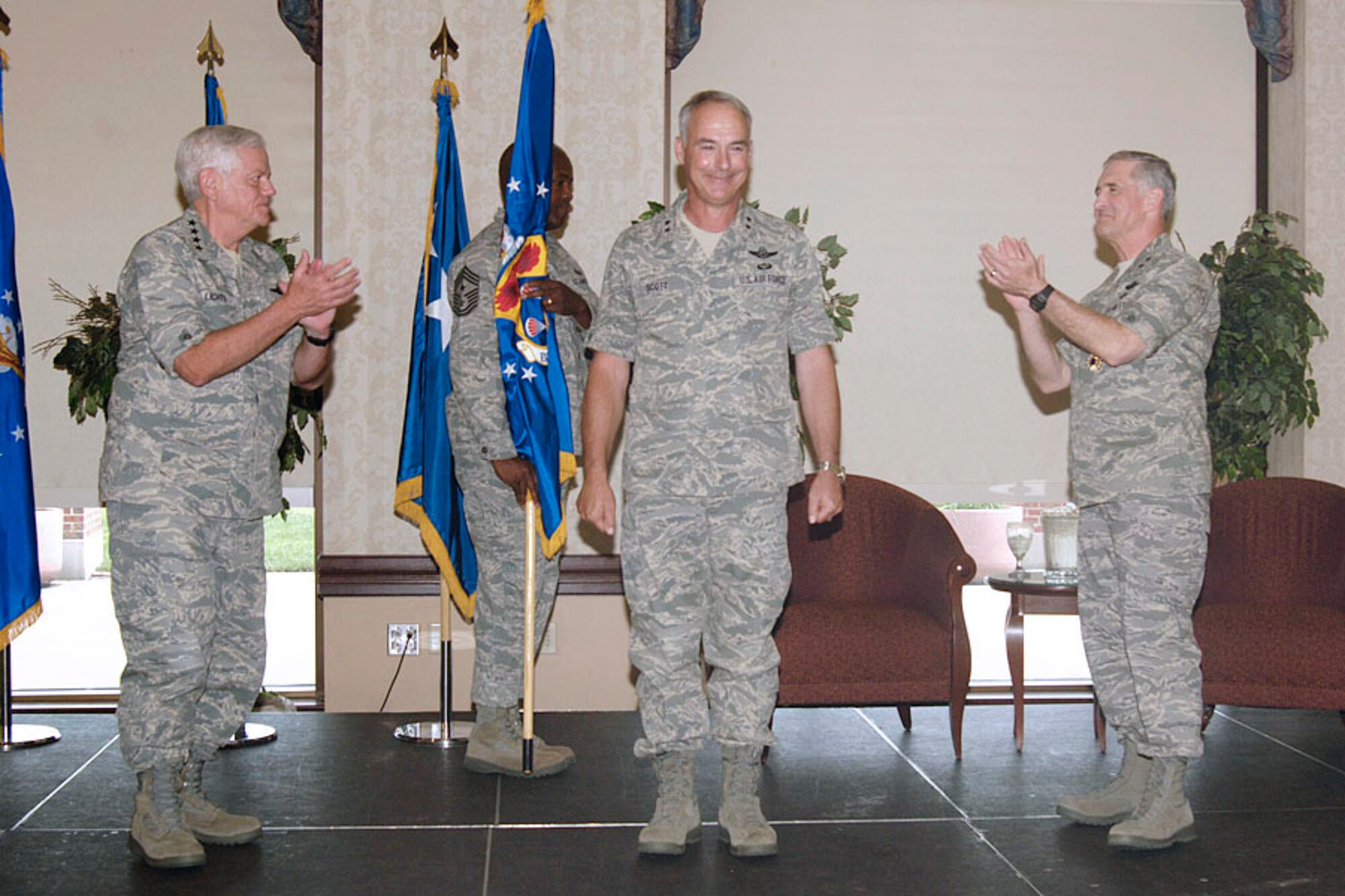 General Arthur J. Lichte, Air Mobility Command commander (left), and Major General James A. Hawkins, former 18th Air Force commander (right), congratulate Major General Winfield W. Scott III  for being named the new 18th Air Force commander during a change-of-command ceremony at the Scott Club on June 24.  (Photo by Senior Airman Jonathan Lovelady)
