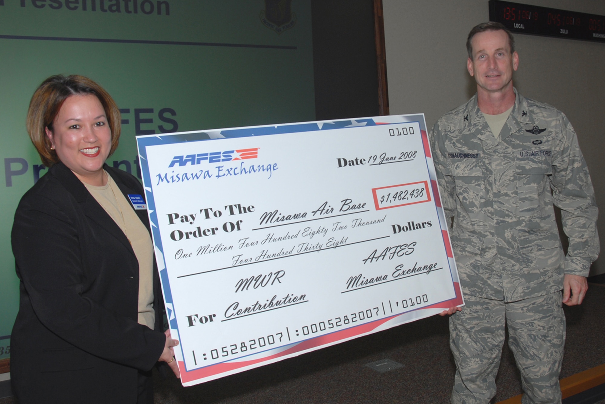 MISAWA AIR BASE, Japan -- Col. T.J. O'Shaughnessy, 35th Fighter Wing commander, receives the annual Morale, Welfare and Recreation (MWR) contribution check from Anna Iosefo, general manager of Misawa Exchange, June 19, 2008.  This year, Misawa received almost $1.5 million, an increase of four percent from last year.  "Roughly two-thirds of the Army and Air Force Exchange Services earnings are paid to MWR programs.  In the past 10 years, $2.4 billion has been contributed by AAFES to military MWR programs to spend on quality of life improvements, including youth services, Armed Forces Recreation Centers, arts and crafts, aquatic centers, post functions and golf courses," said Ms. Iosefo.  (U.S. Air Force photo by Senior Airman Laura R. McFarlane)

by AAFES to military MWR programs to spend on quality of life improvements, including youth services, Armed Forces Recreation Centers, arts and crafts, aquatic centers, post functions and golf courses. In addition to funding MWR programs, AAFES earnings are used to build new stores or renovate existing facilities. Funds to build these new or replacement facilities come entirely from the sale of merchandise and services.
 (U.S. Air Force photo by Senior Airman Laura R. McFarlane)