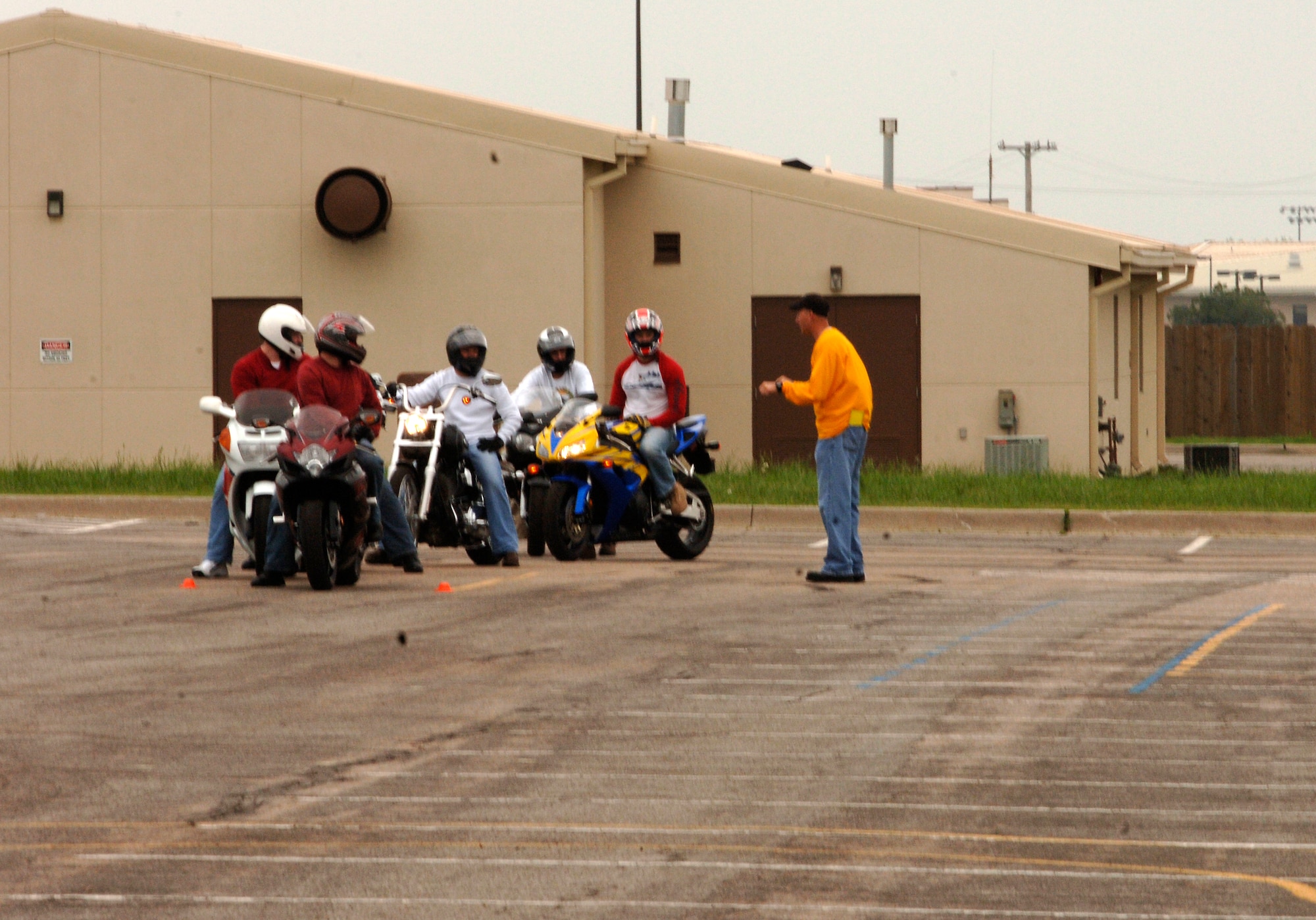 MCCONNELL AIR FORCE BASE, Kan. -- A basic riding course instructor pulls a few motorcycle riders to the side of the course, and gives them a brief refresher on the proper way to handle curves. All of the riders in the base safety office’s BRC were supervised and advised on ways to improve their riding ability during the two day course. (Photo by Airman Justin Shelton)