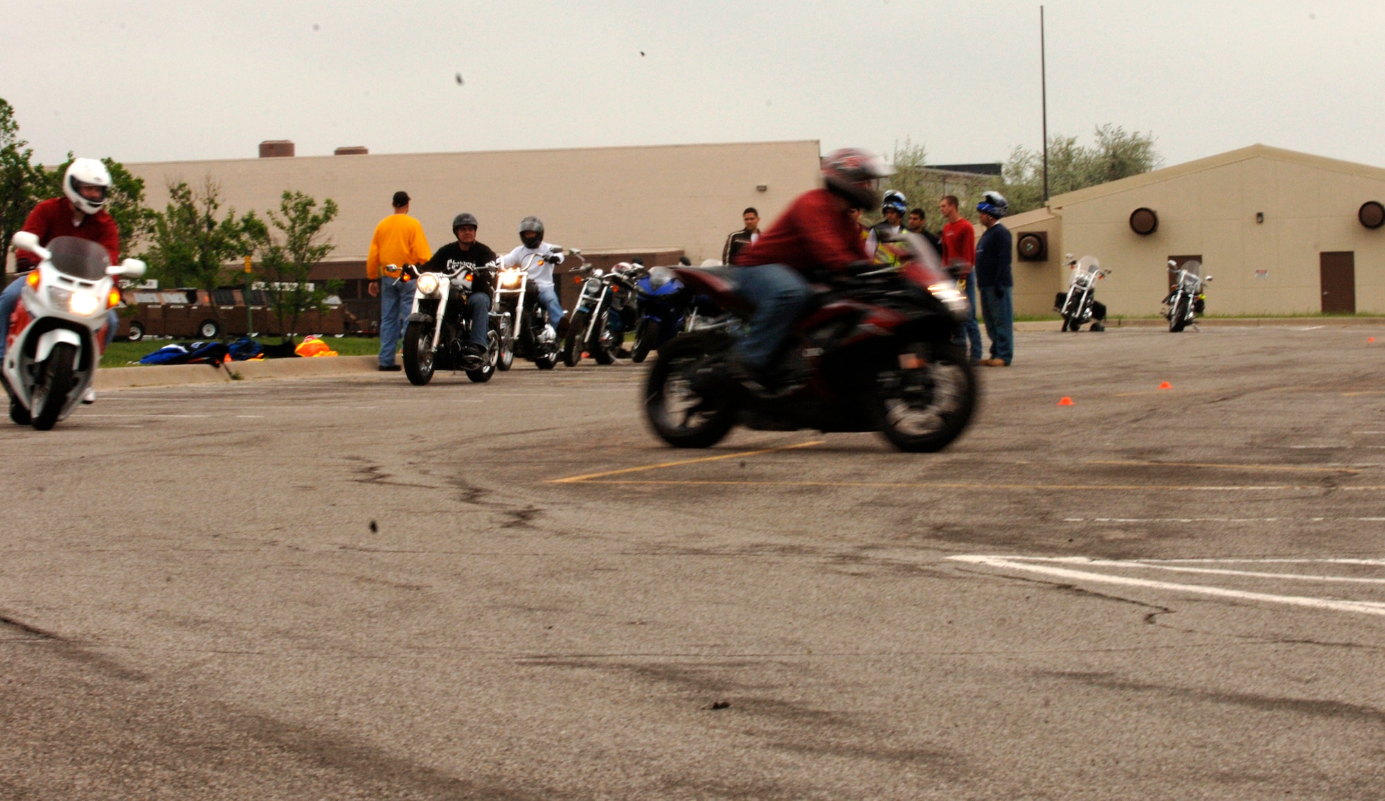 MCCONNELL AIR FORCE BASE, Kan. -- Riders who participate in the base safety office’s basic riding course launch off in pairs from their starting line. All of the riders were given a chance to practice different types of turns and obstacle navigation in order to assist them in events that might arise in their daily motorcycle riding. (Photo by Airman Justin Shelton)