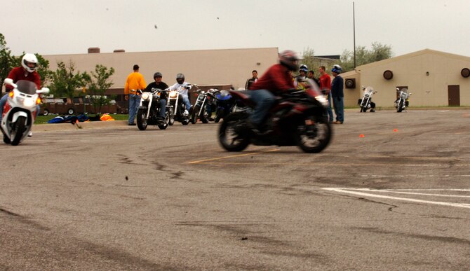 MCCONNELL AIR FORCE BASE, Kan. -- Riders who participate in the base safety office’s basic riding course launch off in pairs from their starting line. All of the riders were given a chance to practice different types of turns and obstacle navigation in order to assist them in events that might arise in their daily motorcycle riding. (Photo by Airman Justin Shelton)