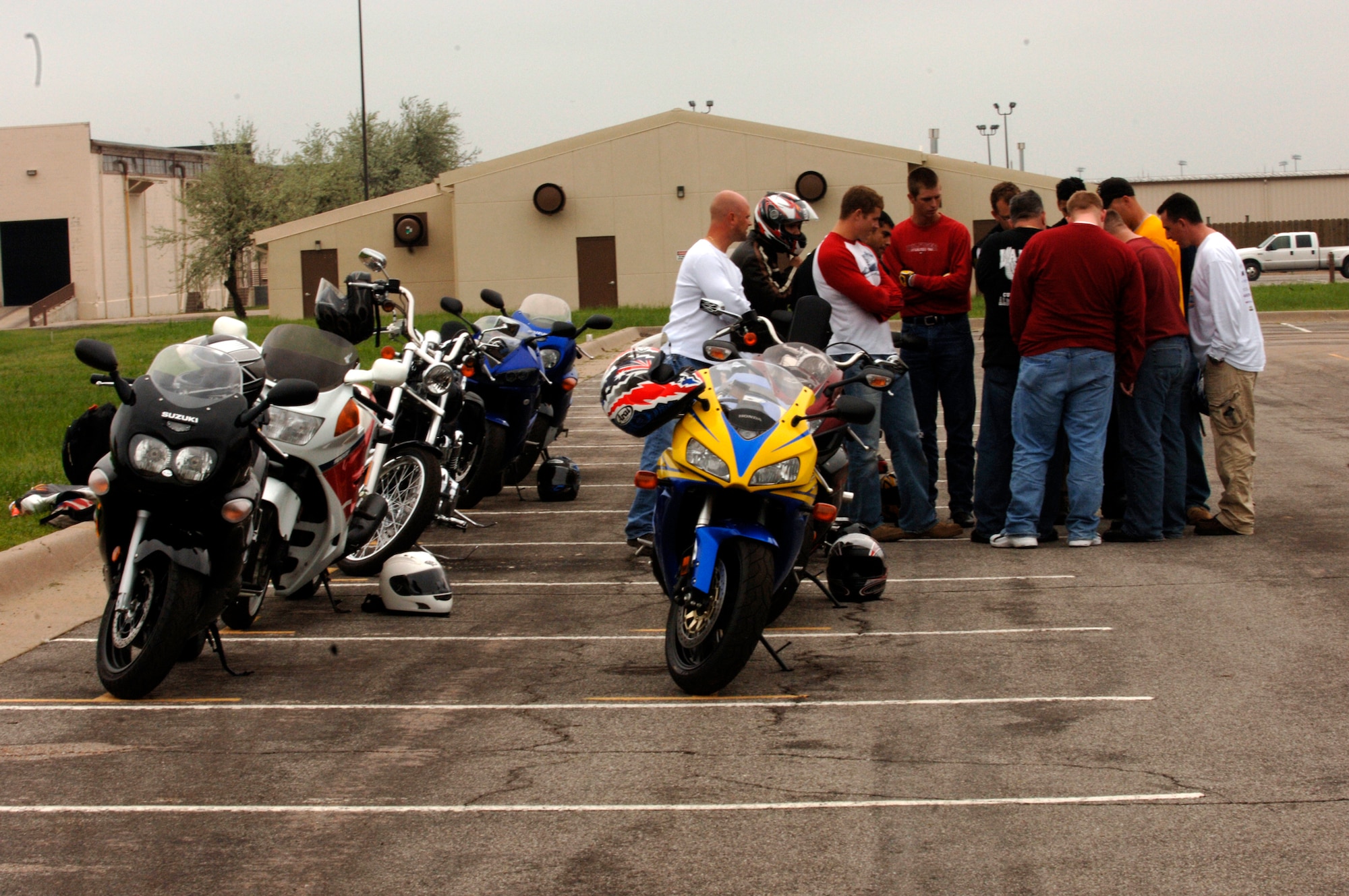 MCCONNELL AIR FORCE BASE, Kan. -- The base safety office hosts a basic motorcycle riding course to train new rider’s ways to stay safe. Basic rider’s course students class huddled together to listen to the instructor brief the order of the maneuvers that they were going to demonstrate, to show the instructors that they could competently perform what was learned in the classroom. (Photo by Airman Justin Shelton)