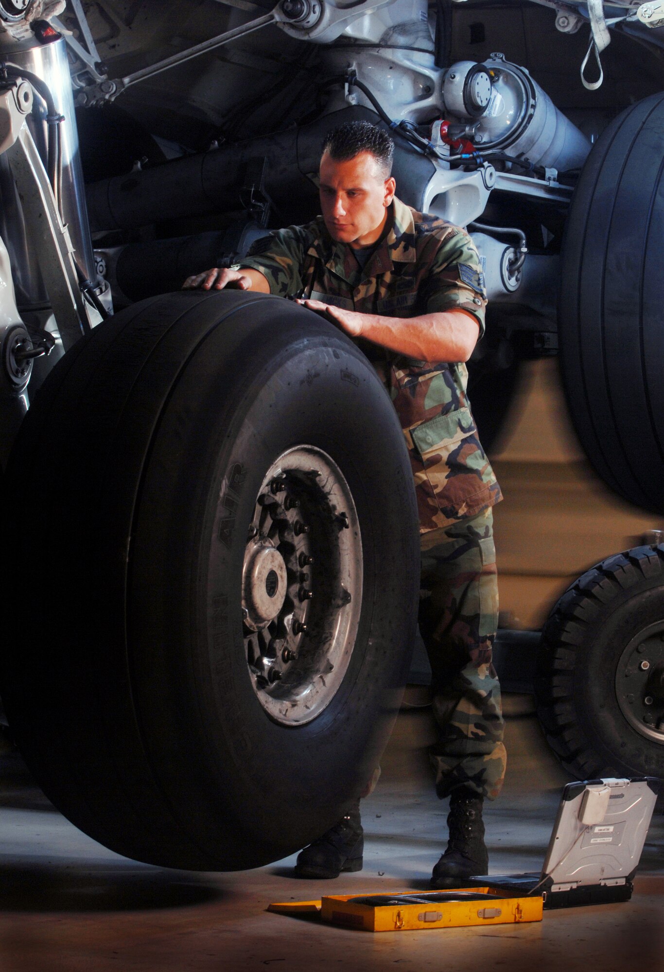 Staff Sgt. Brian Hicks, an aircraft mechanic from the 452nd Maintenance Squadron, checks the condition of a tire on a C-17 Globemaster III cargo aircraft at March Air Reserve Base, Calif. The aircraft is sitting on jack stands while undergoing routine inspection. (U.S. Air Force photo by Val Gempis)
