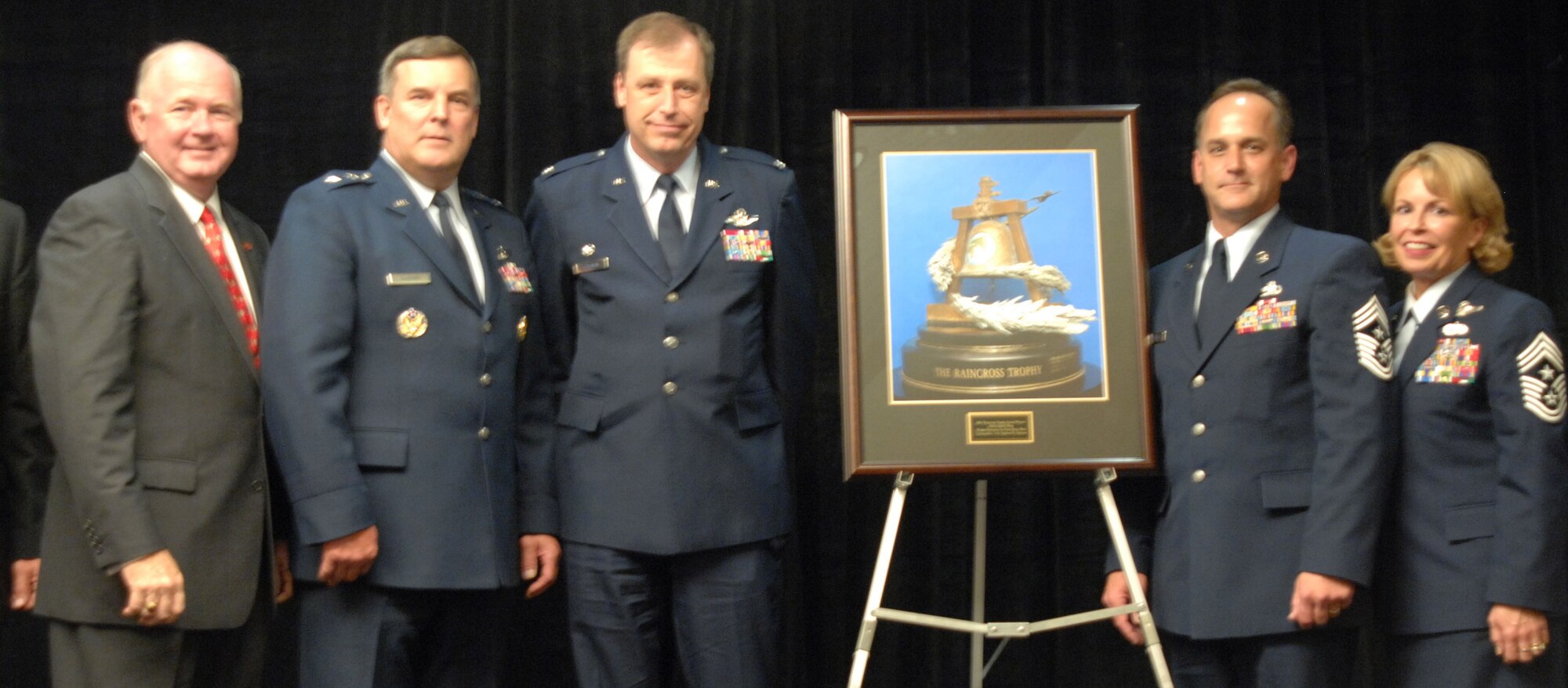 2007 RAINCROSS TROPHY: From left to right, Lieutenant General Jimmy Sherrard (ret); Major General Bob Duignan, Commander, Fourth Air Force; Colonel Stephen Goeman, and Command Chief Master Sergeant Aaron Mouser with the 445th Airlift Wing from Wright-Patterson AFB, Ohio; along with Fourth Air Force Command Chief Master Sergeant Patricia Thornton, with the 2007 Raincross Trophy Award presented at the 10th Annual Raincross Trophy Dinner held at the Riverside Convention Center in Riverside, California, on Saturday. (U. S. Air Force photo by Senior Master Sgt. Kim Allain)
