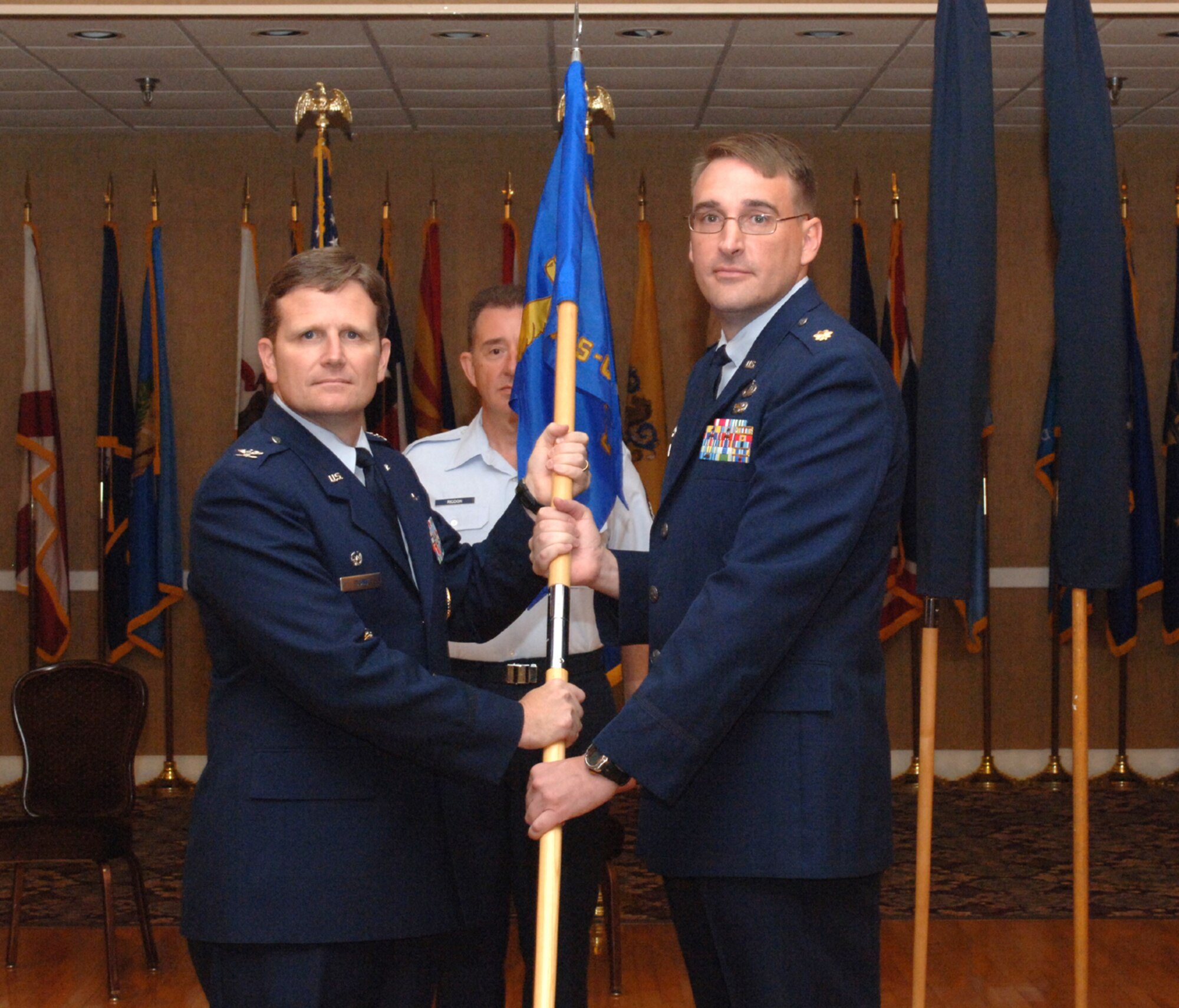 Colonel Jeff Dunn, 14th Flying Training Wing interim wing commander, presents Maj. Paul Porter with the new 14th Contracting and Comptroller Squadron (Provisional) guidon June 24 at the Columbus Club. Major Porter assumed command of the newly established 14th CONS-CPTS (P) during the ceremony. (U.S. Air Force photo by Airman Josh Harbin)