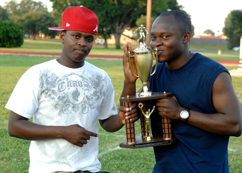 BARKSDALE AIR FORCE BASE, La.- Airman 1st Class Blaise Muluh and Airman James Njoroge accept the 2008 National League soccer championship trophy for the 2d Medical Squadron soccer team at the Barksdale fitness center field June 19, 2008. (US Air Force Photo by Amn Benjamin McWha)