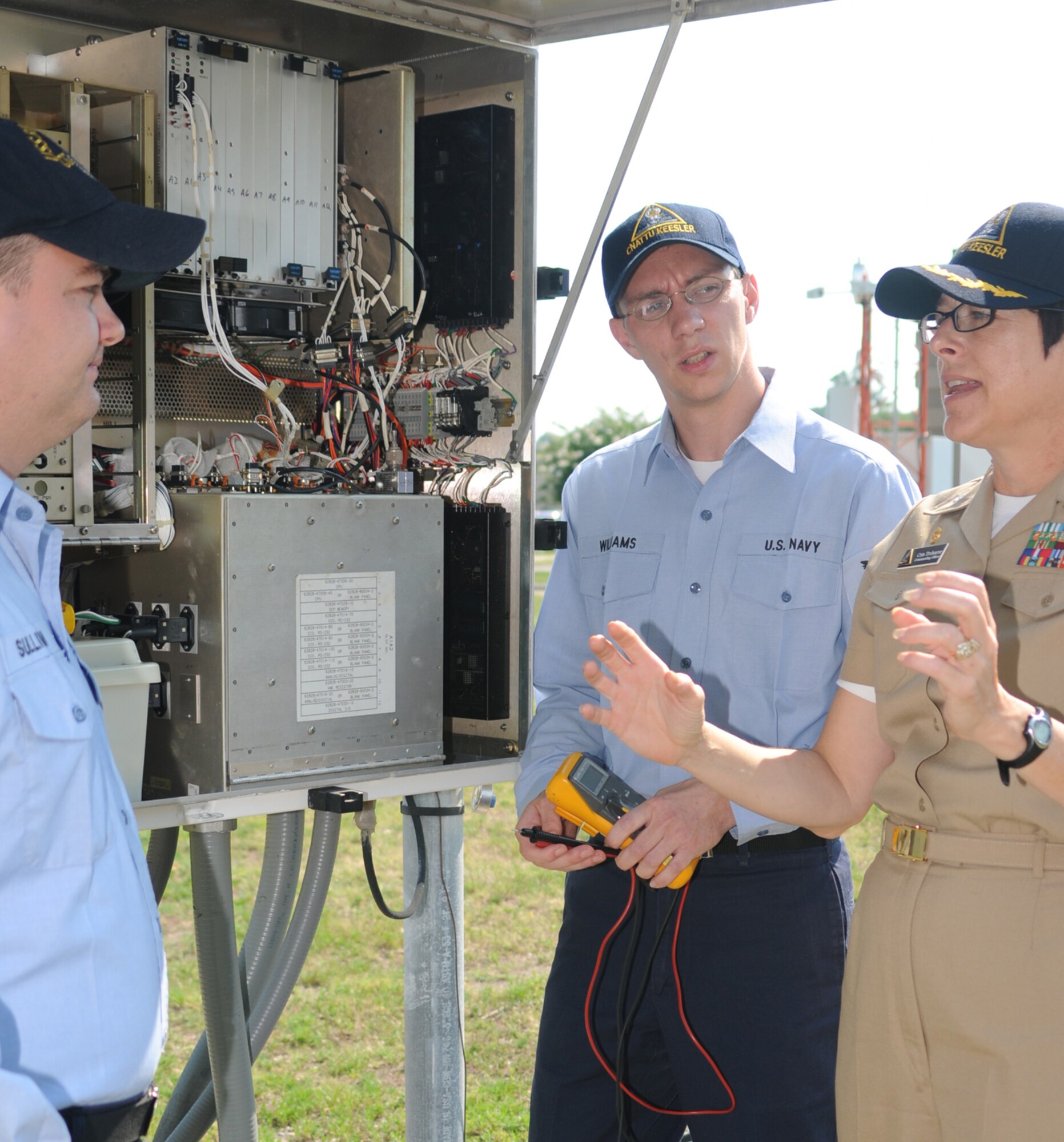 From left, Electronics Technician 2nd Class Wil-liam Sullivan and ET3 Daniel Williams, students in the Center for Naval Aviation Technical Training Unit, discuss data collection processing equipment with Cmdr. Cristy Treharne, the unit’s new commander, June 19 outside Allee Hall.  Commander Treharne came to Keesler from the Defense Intelligence Agency. She took command from Cmdr. Dean Sadanaga June 12.  Commander Sadanaga is now assigned to Stennis Space Center in Hancock County.  (U.S. Air Force photo by Kemberly Groue)