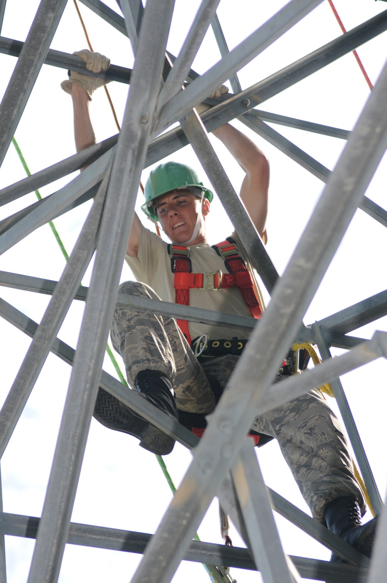 Airman Basic Joshua Cochran, an airfield systems apprentice student  in the 338th Training Squadron, climbs a 53-foot tower behind Maltby Hall on his first day of climbing training, June 18.  Last week was the first time climbing skills have been incorporated in the course.  (U.S. Air Force photo by Kemberly Groue)