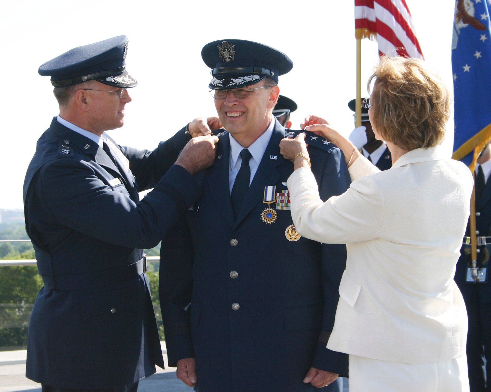 Lt. Gen. John A. Bradley, left, outgoing chief of Air Force Reserve Command, pins a third star on the epaulet of Lt. Gen. Charles Stenner Jr.; while Mrs. Dee Stenner pins the epaulet on the other side. The promotion ceremony was at the Air Force Memorial in Arlington, Va., June 24. (U.S. Air Force photo/Senior Master Sgt. Raymond Sarracino)