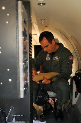 Maj. Mark Jeffries, Mission Systems Officer in the 130th Airlift Wing out of Clarksburg, W. Va., packs up after a flood damage assessment in Indiana June 11. Jeffries was one of several pilots to fly over Indiana in the Reconnaissance Cargo - 26B (RC-26B), providing live footage of the area to the Indiana National Guard.