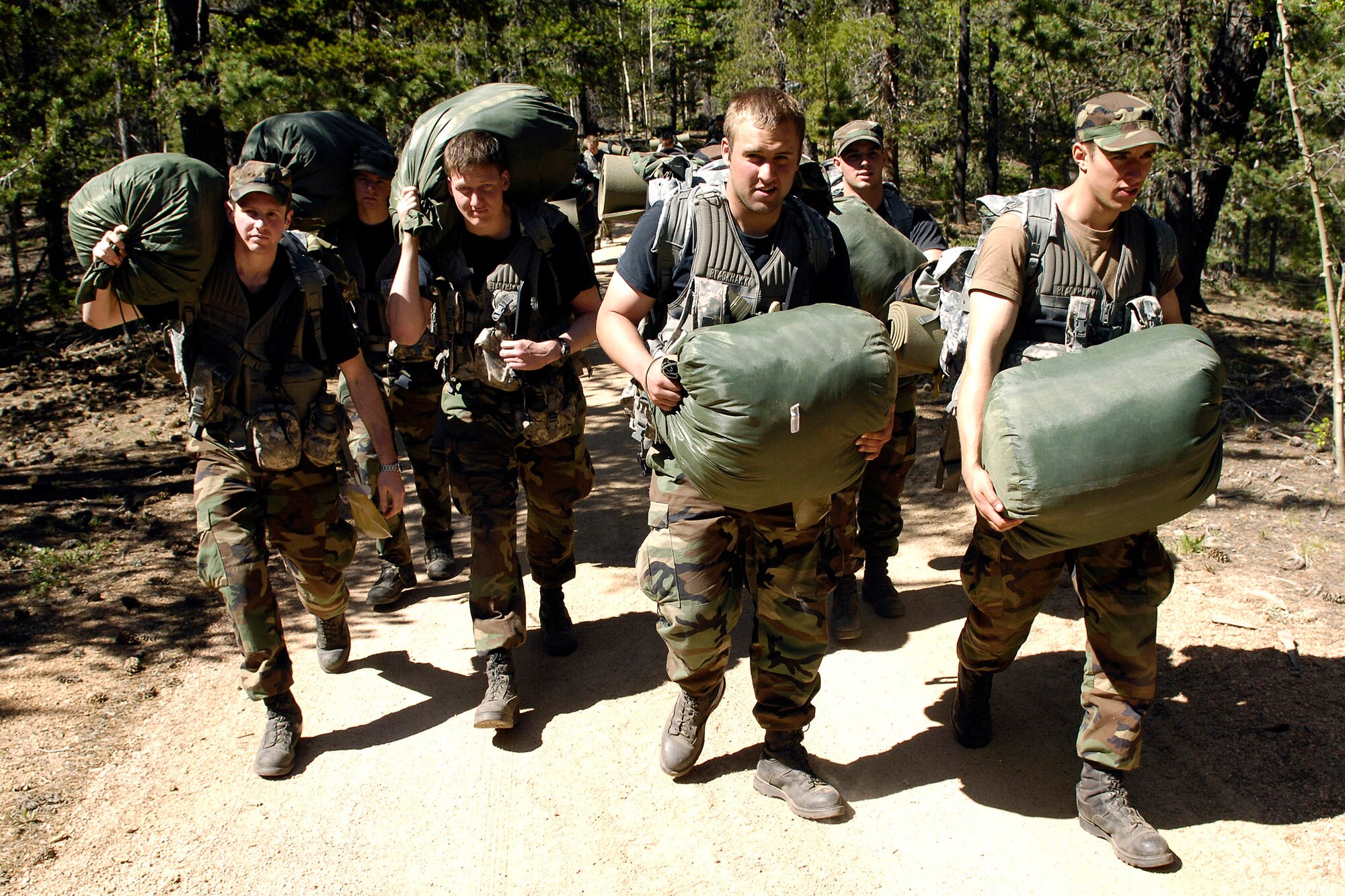Air Force Academy cadets enter a wooded area June 9, where they will set up camp in Saylor Park, Colo. More than 600 cadets are being trained as instructors in survival, evasion, resistance and escape tactics during the 2008 summer period. (U.S. Air Force photo/Mike Kaplan)
