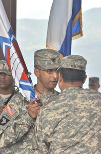 Col. Otto Boneta takes the Medical Element unit colors from Col. Marcus De Oliveira, Joint Task Force-Bravo commander, during a change of command ceremony June 24 at Soto Cano Air Base, Honduras. The former MEDEL commander, Col. Michael Sigmon, moves to his new assignment as chief of preventative medicine at Tripler Army Medical Center, Honolulu, Hawaii. MEDEL provides Level I-III medical treatment for all Department of Defense health care beneficiaries in Central America, and supports all humanitarian assistance, disaster relief and personnel recovery missions in the area of responsibility. (Photo by Martin Chahin)                               