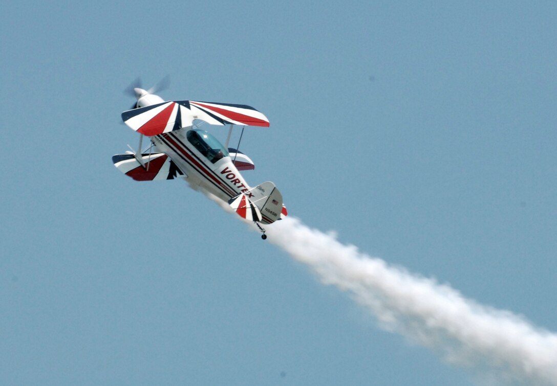 LANGLEY AIR FORCE BASE, Va. -- Ken Appezzato flies his biplane during a demonstration at Air Power over Hampton Roads here June 22. Langey's open house is an annual event that helps educate the public, increase recruiting and show appreciation to the local community. (U.S. Air  Force photo/Airman Rebecca Montez)