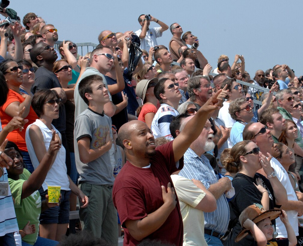 LANGLEY AIR FORCE BASE, Va. -- Spectators watch the arial performances during Air Power over Hampton Roads here June 22.  Langley's open house is an annual event that helps educate the public, increase recruiting and show appreciation to the local community. (U.S. Air  Force photo/Airman Rebecca Montez)