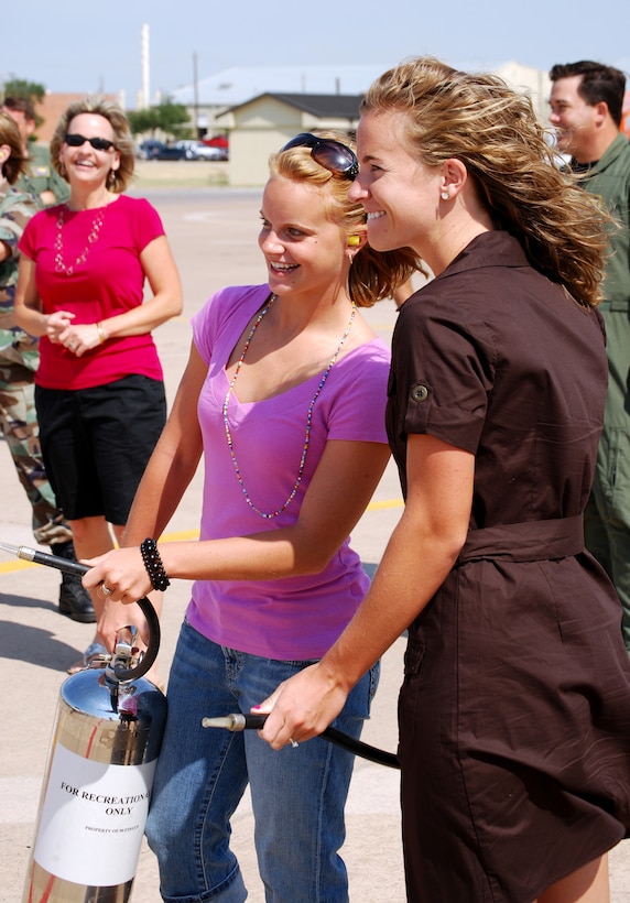 Bailey, center, and Carson McGowan prepare to soak their father, 97th Flying Training Squadron Commander Lt. Col. Bo McGowan, June 24 after he logged his 4,000th flying hour in the T-37 Tweet. Colonel McGowan has amassed 6,154.1 flying hours in his 24-year Air Force and Air Force Reserve career. (U.S. Air Force photo/John Ingle)