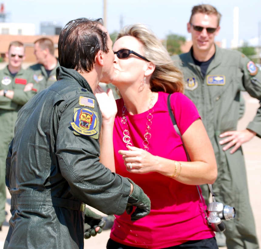 Kelley McGowan congratulates her husband, Lt. Col. Bo McGowan, June 24 after he reached the uncommon feat of 4,000 flying ours in the T-37 Tweet. The 97th Flying Training Squadron commander has accumulated 6,154.1 flying hours during his Air Force and Air Force Reserve career. (U.S. Air Force photo/John Ingle)
