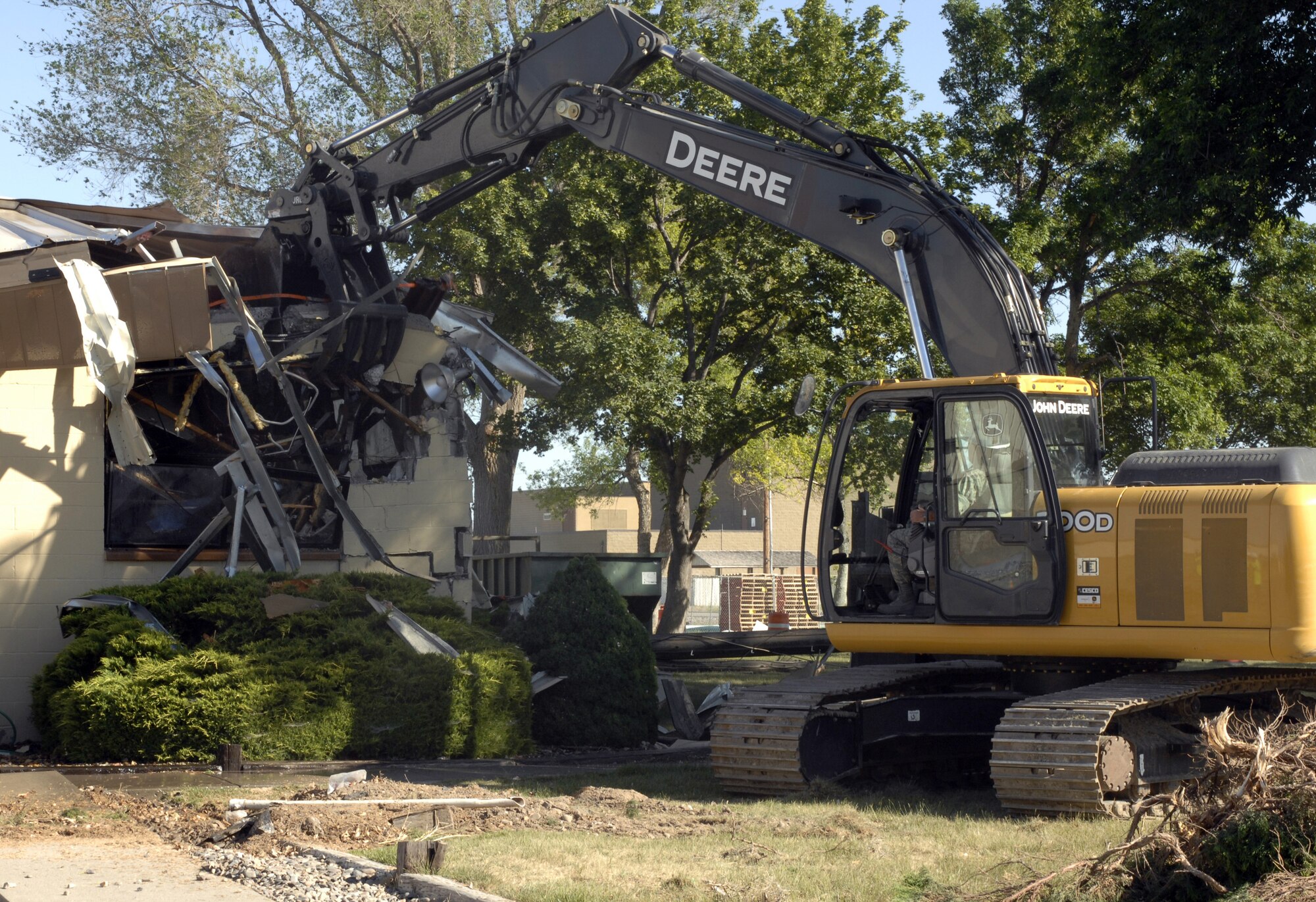 MOUNTAIN HOME AIR FORCE BASE, Idaho - Col. James Browne, 366th Fighter Wing commander, uses an excavator to demolish Building 273. The Air Combat Command consolidation and demolition program initiative includes removing older facilities across the command to improve energy efficiency and eliminate utility and maintenance costs. (U.S. Air Force photo/ Airman 1st Class Ashley Winters) 