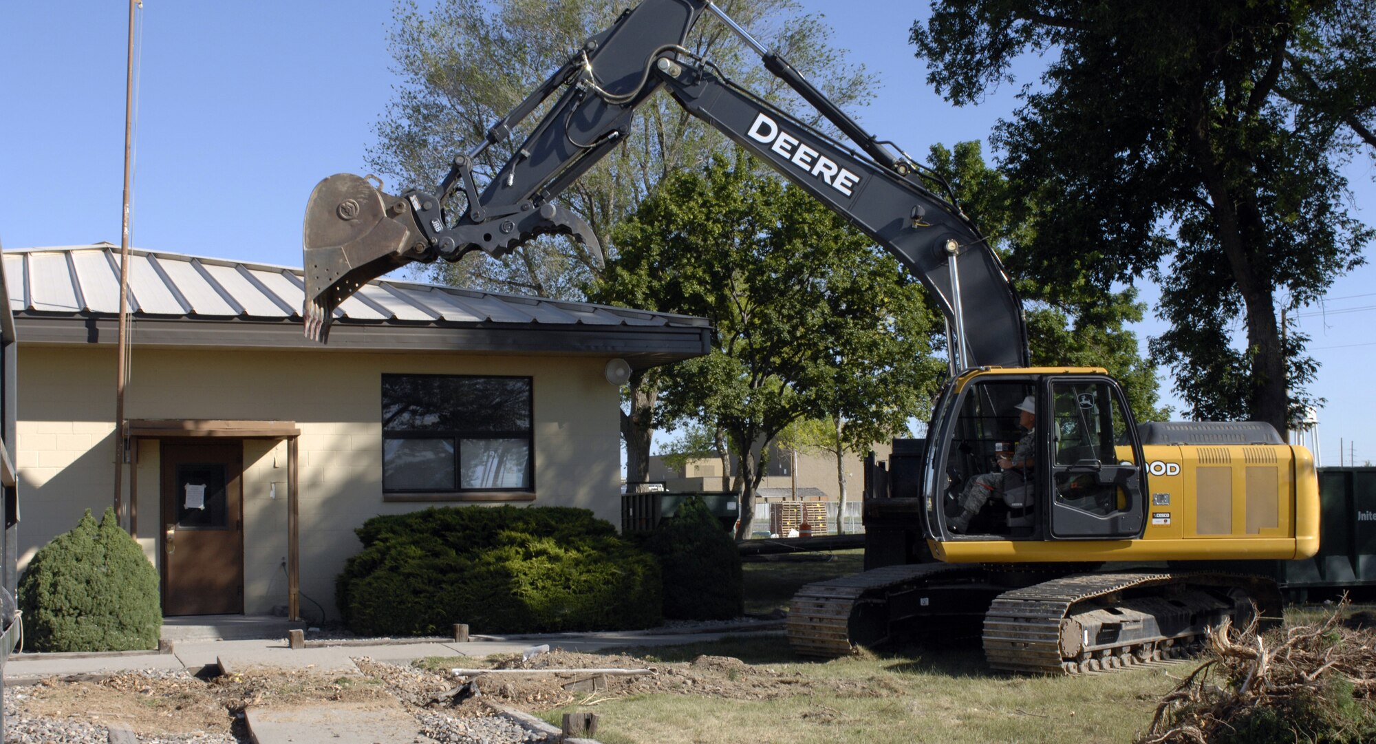 MOUNTAIN HOME AIR FORCE BASE, Idaho - Col. James Browne, 366th Fighter Wing commander, uses an excavator to demolish Building 273. The Air Combat Command consolidation and demolition program initiative includes removing older facilities across the command to improve energy efficiency and eliminate utility and maintenance costs. (U.S. Air Force photo/ Airman 1st Class Ashley Winters) 