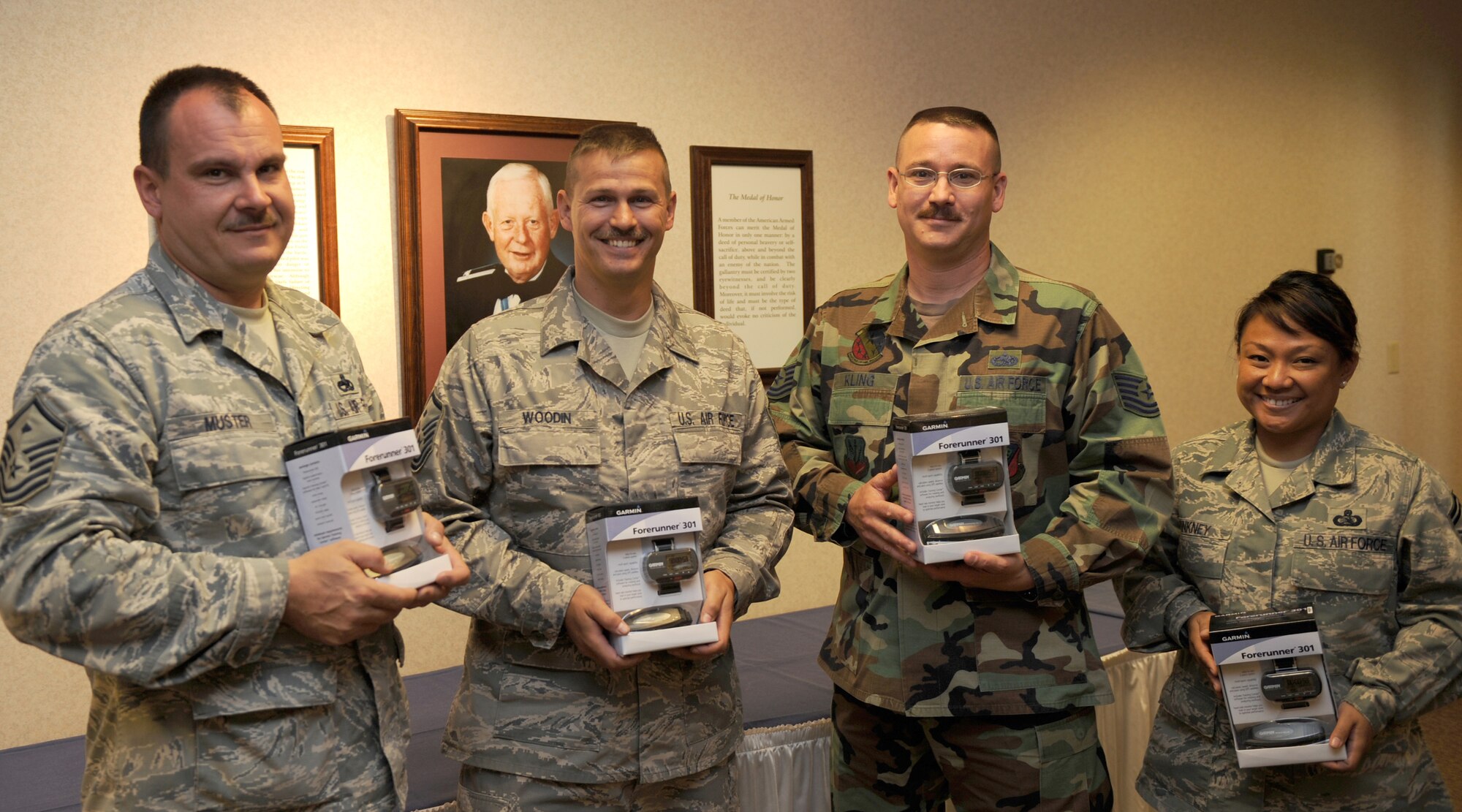 MOUNTAIN HOME AIR FORCE BASE, Idaho - (left to right) Master Sgt. Mark Muster, 366th Operations Support Squadron first sergeant, Master Sgt. Robert Woodin, 366th Civil Engineer Squadron first sergeant, Tech. Sgt. Terry Kling, 366th Component Maintenance Squadron, and Senior Master Sgt. Christine Pinkney, 726th Air Control Squadron, receive their awards from the Top 3 Run-A-Thon June 16 at the Gunfighters Club. Sergeant Muster accepted the award for Tech. Sgt. Neil Young. The Run-A-Thon raised money for numerous charities. Sergeant Young raised more than $1,000 and was awarded a Garmin 301 Global Positioning System and heart monitor. Sergeant Woodin raised $900, Sergeant Pinkney, raised $400 and Sergeant Kling raised $400, and even though only one prize was advertised, the Top 3 gave them GPS systems as well. (U.S. Air Force photo/ Airman 1st Class Stephany Miller) 