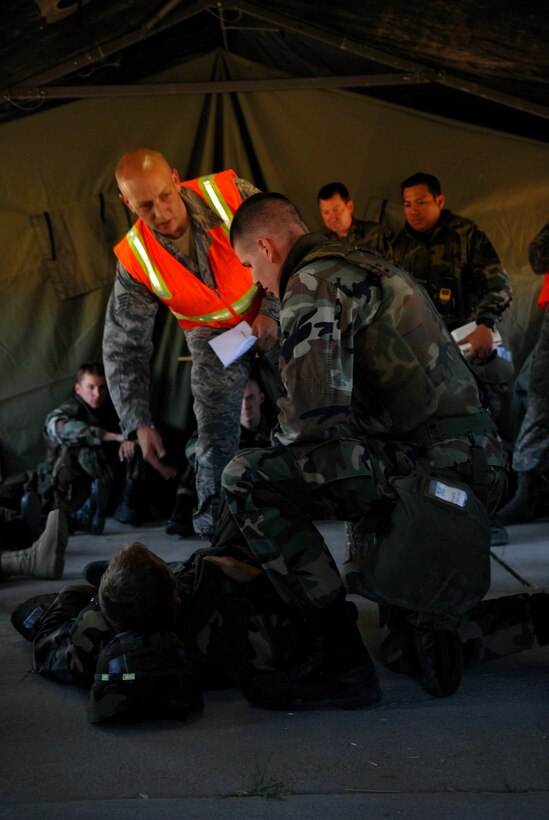 VANDENBERG AIR FORCE BASE, Calif. -- Master Sgt. Andrew Colsch, an instructor for the Exercise Evaluation Team, shows Airmen how to check for breathing on a mock casualty during the North Star exercise here June 18. (U.S. Air Force photo / Senior Airman Christopher Hubenthal)